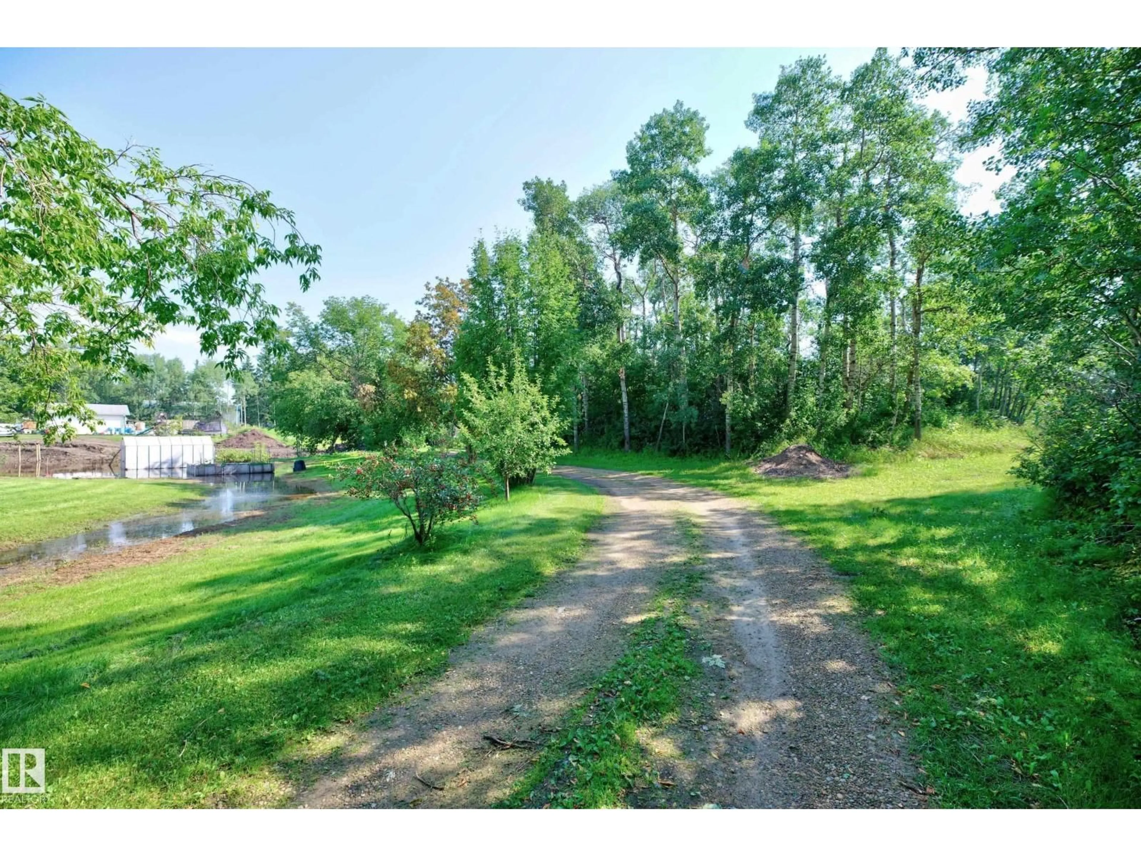 A pic from outside/outdoor area/front of a property/back of a property/a pic from drone, water/lake/river/ocean view for 22559 - 319 WYE RD, Rural Strathcona County Alberta T8C1H9