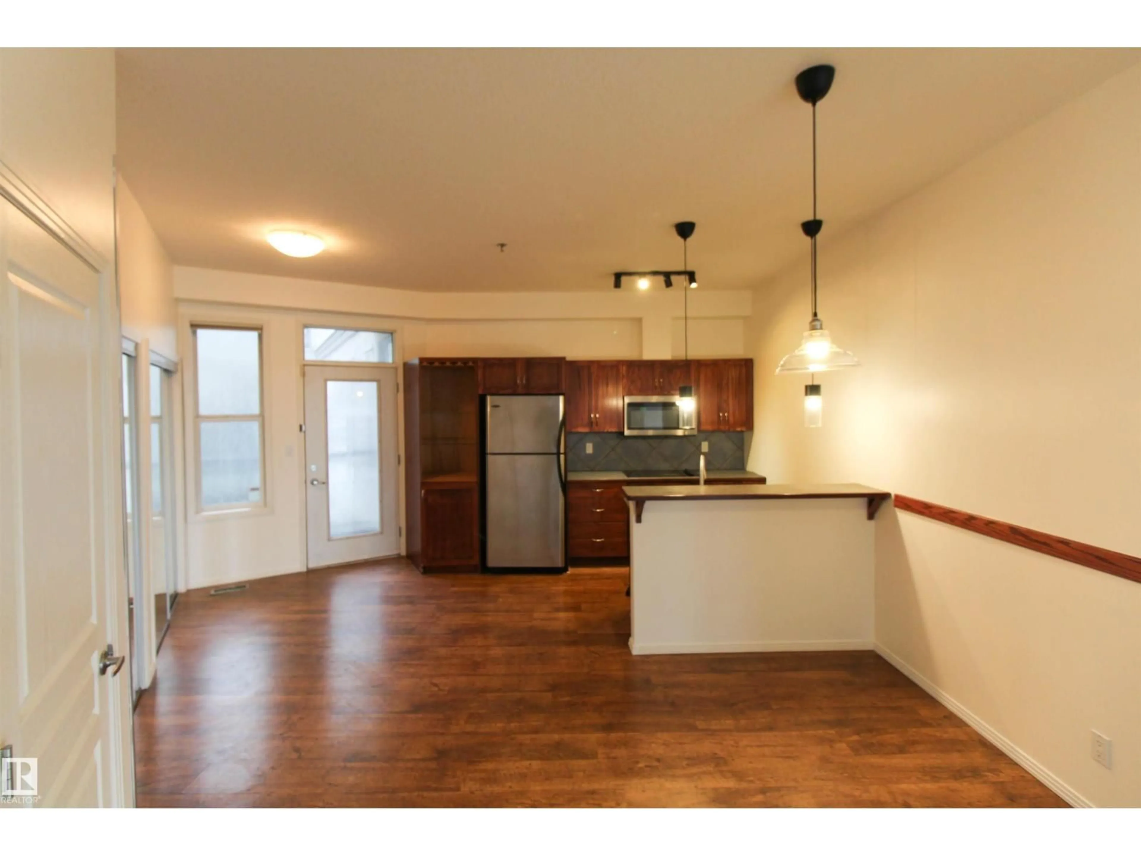 Open concept kitchen, wood/laminate floor for #347 - 4827 104A ST, Edmonton Alberta T6H0K4