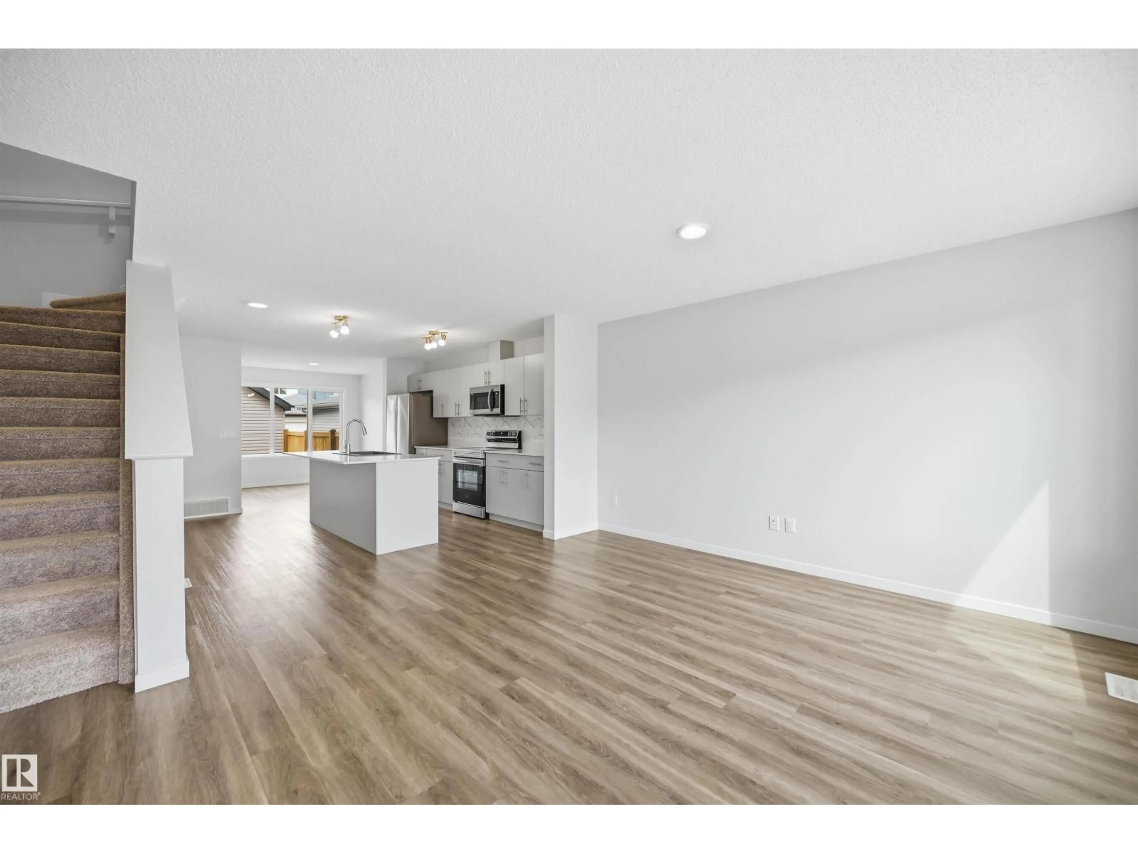Open concept kitchen, wood/laminate floor for NW - 19112 22 AV, Edmonton Alberta T6M1R1