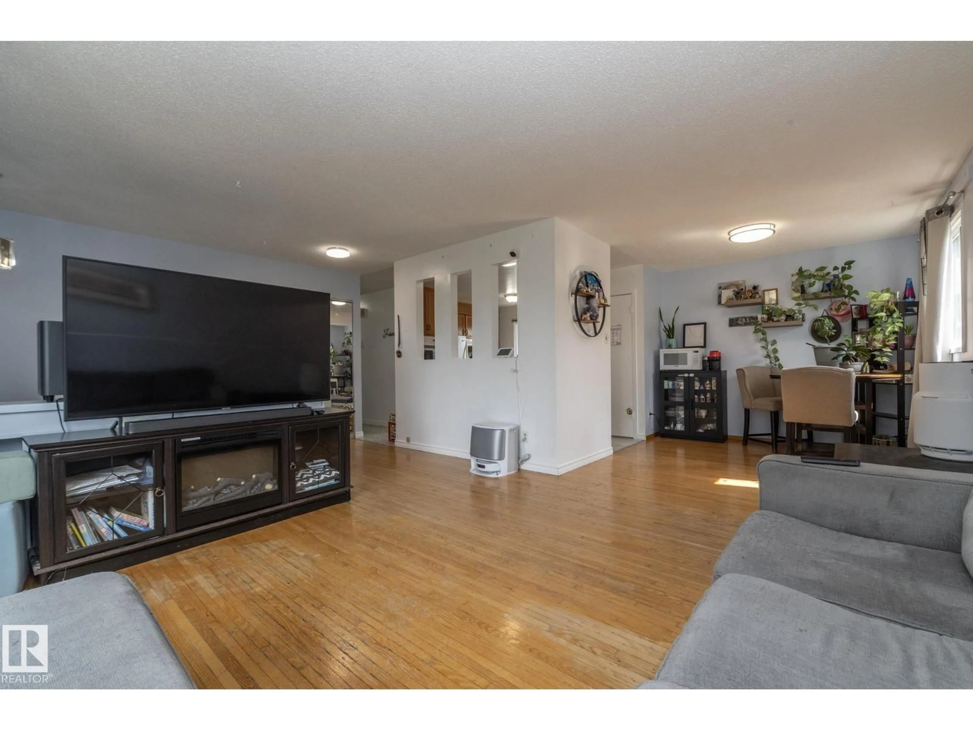 Living room with furniture, wood/laminate floor for NW - 14215 78 ST, Edmonton Alberta T5C1H4