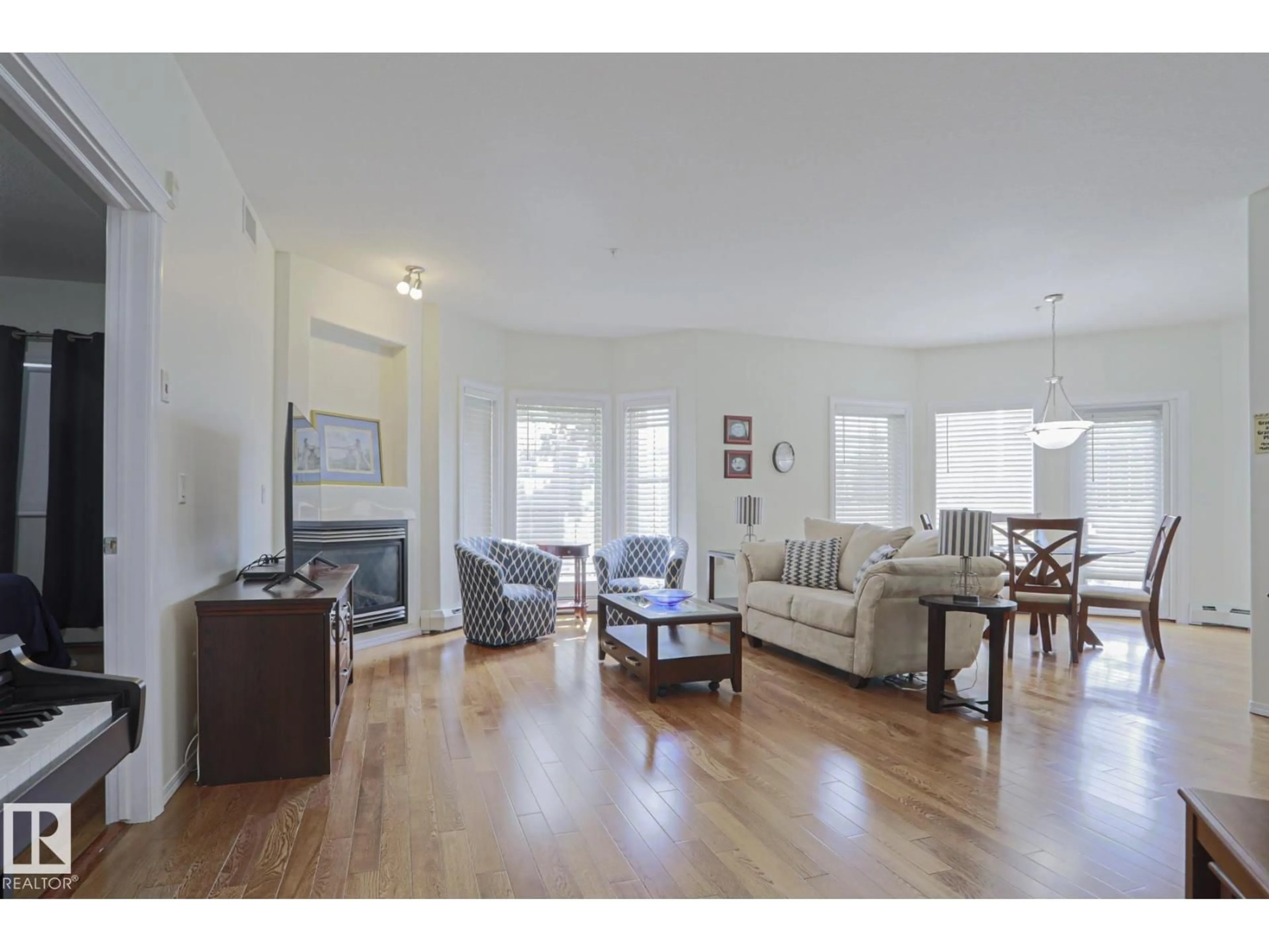 Living room with furniture, wood/laminate floor for 131 - 11260 153 AV, Edmonton Alberta T5X6E7