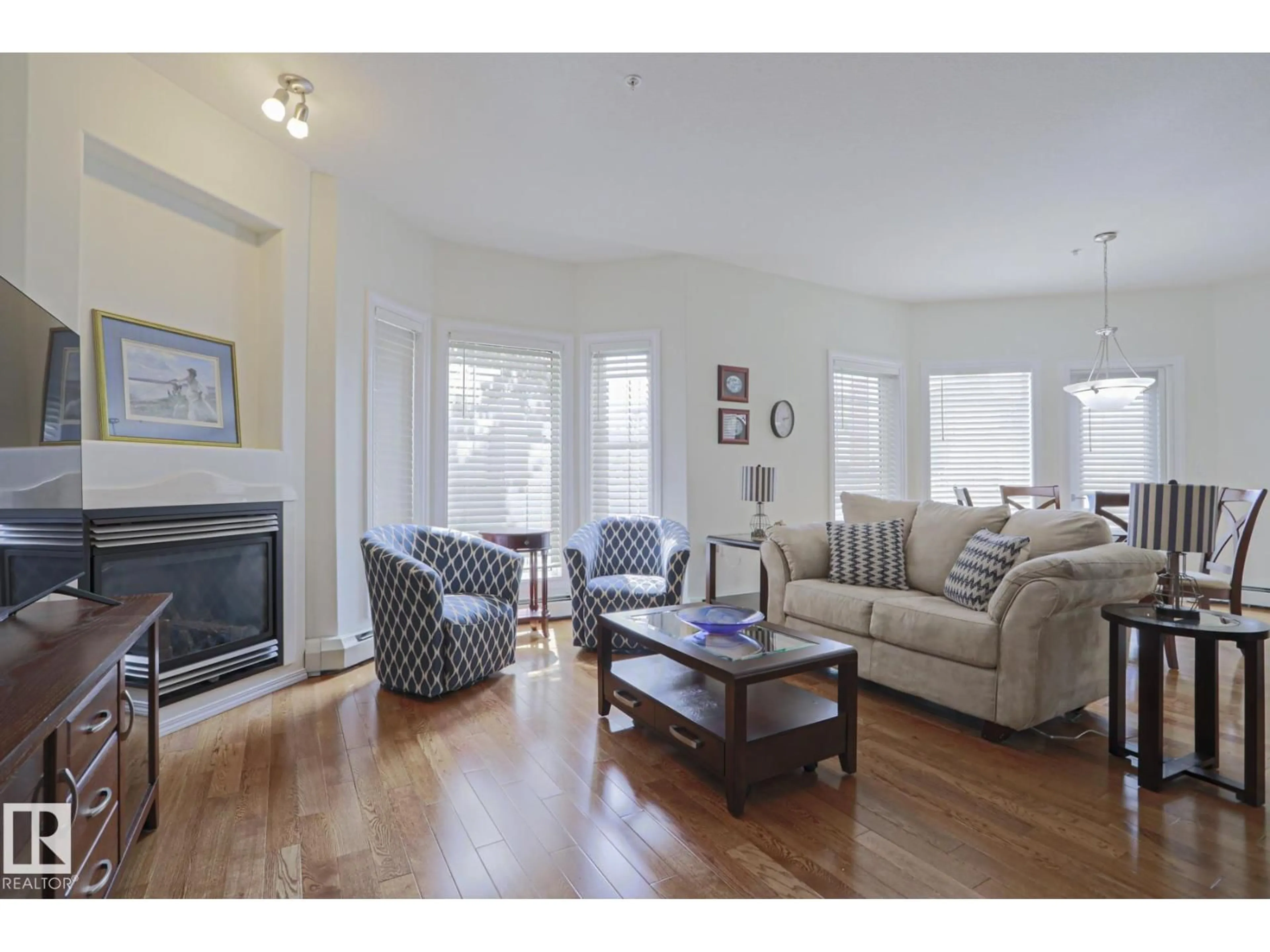 Living room with furniture, wood/laminate floor for 131 - 11260 153 AV, Edmonton Alberta T5X6E7