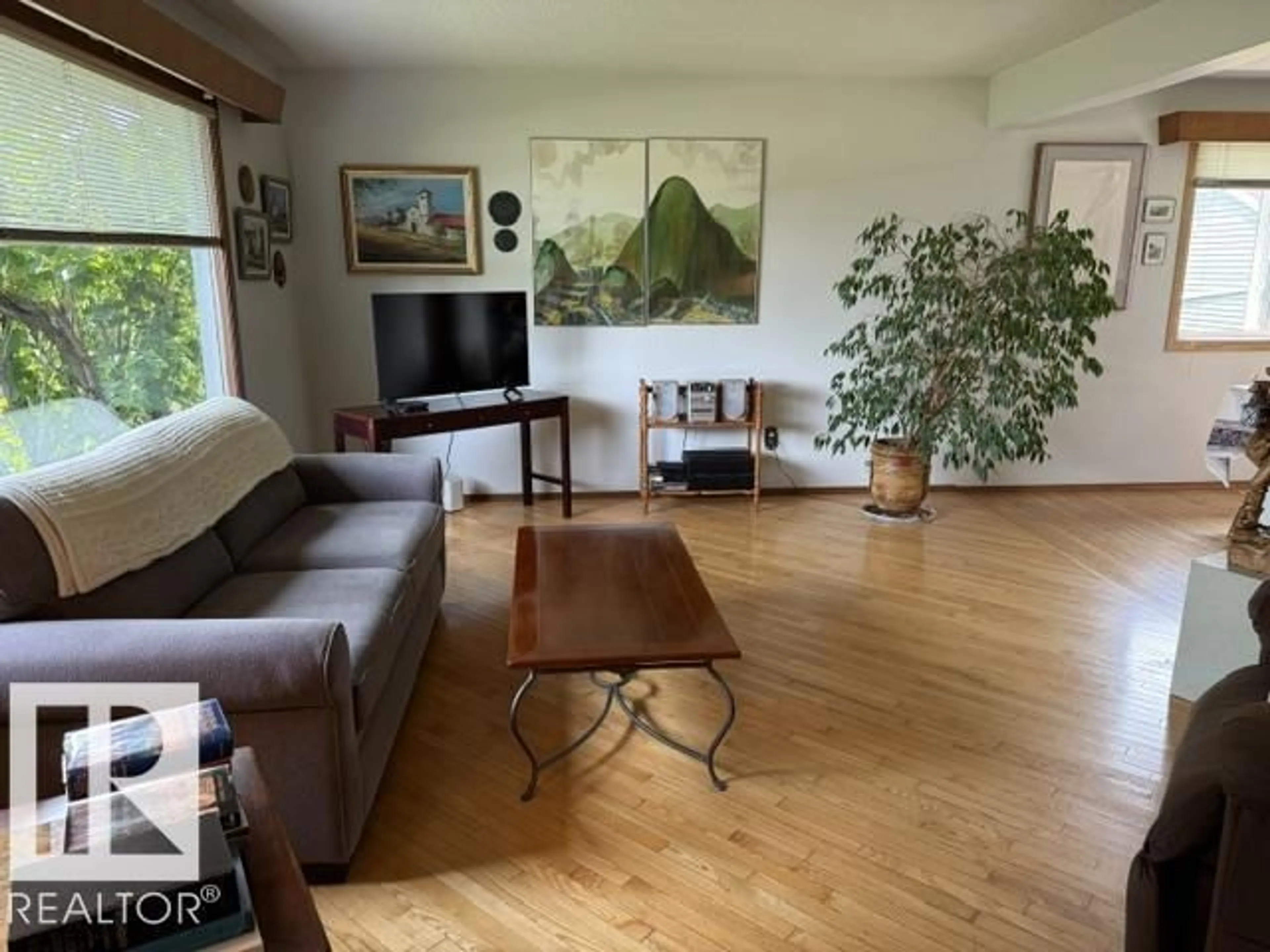 Living room with furniture, wood/laminate floor for NW - 13508 64 ST, Edmonton Alberta T5A0Y9