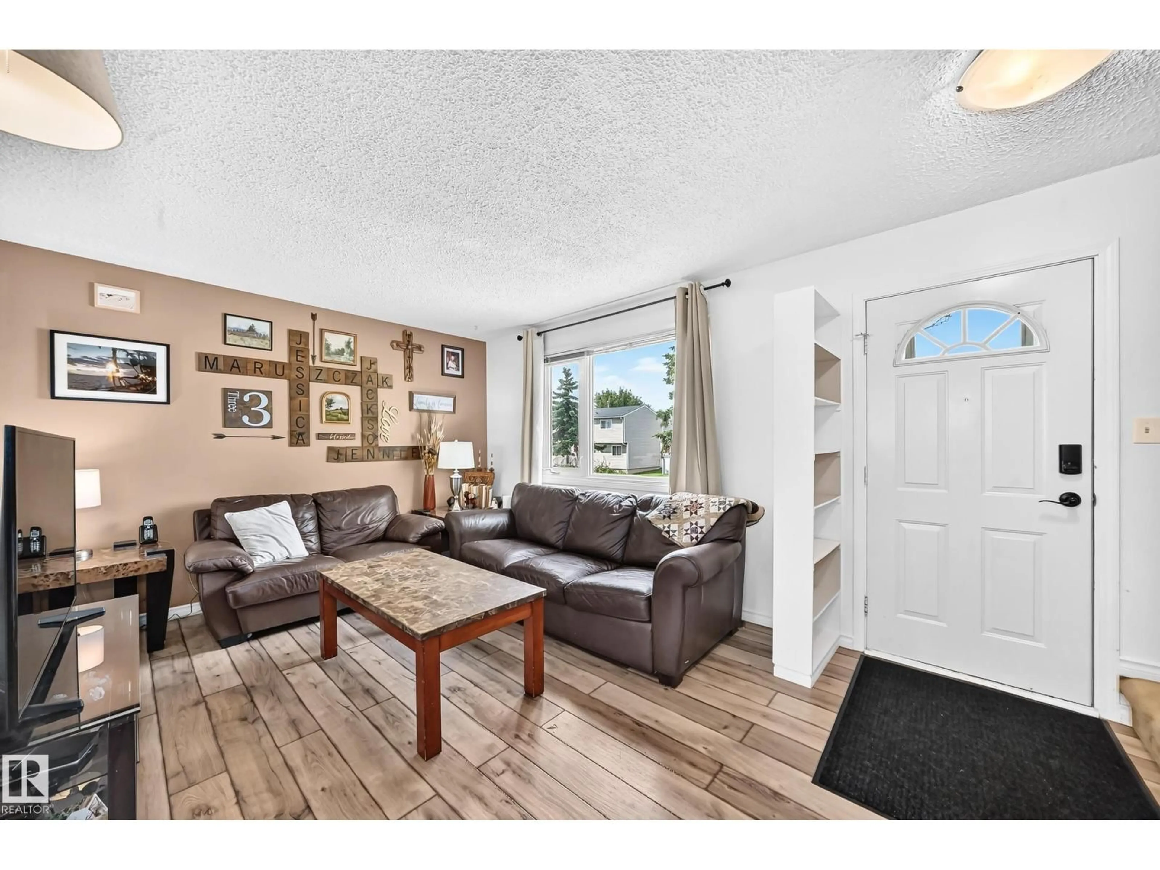 Living room with furniture, wood/laminate floor for 64 HABITAT CR, Edmonton Alberta T5A2X7