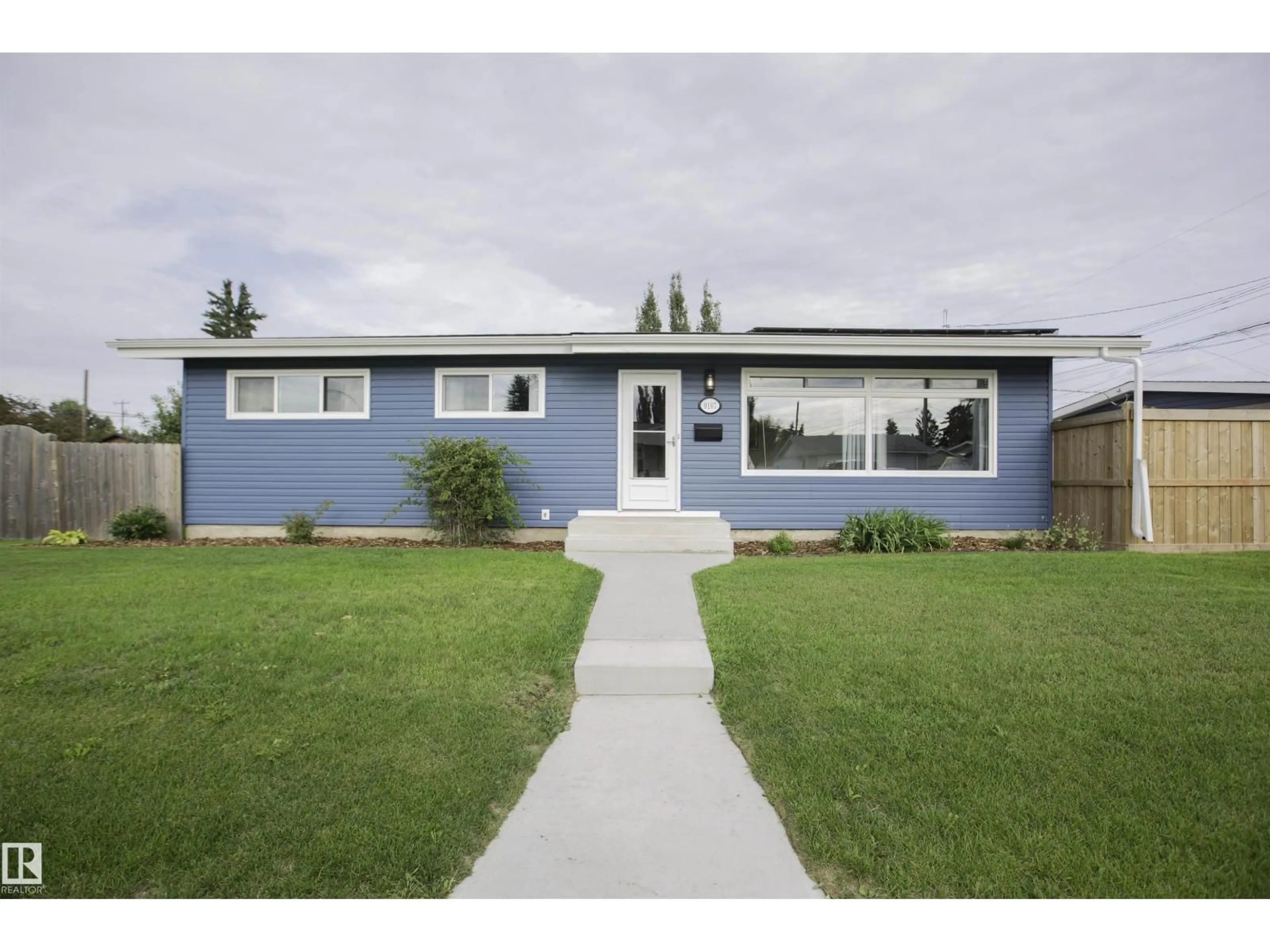 Home with vinyl exterior material, street for 9107 58 ST, Edmonton Alberta T6B1L3