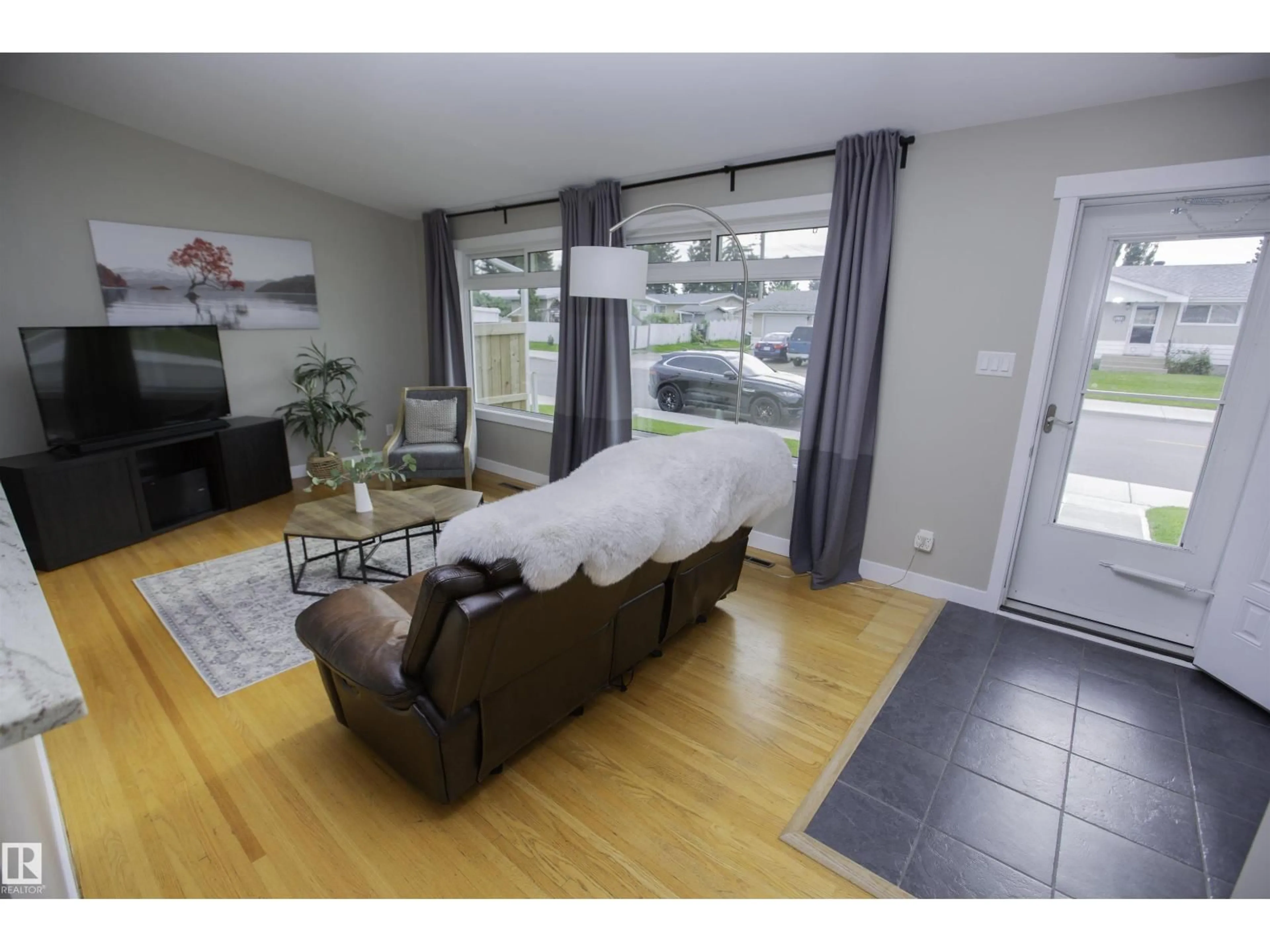 Living room with furniture, wood/laminate floor for 9107 58 ST, Edmonton Alberta T6B1L3