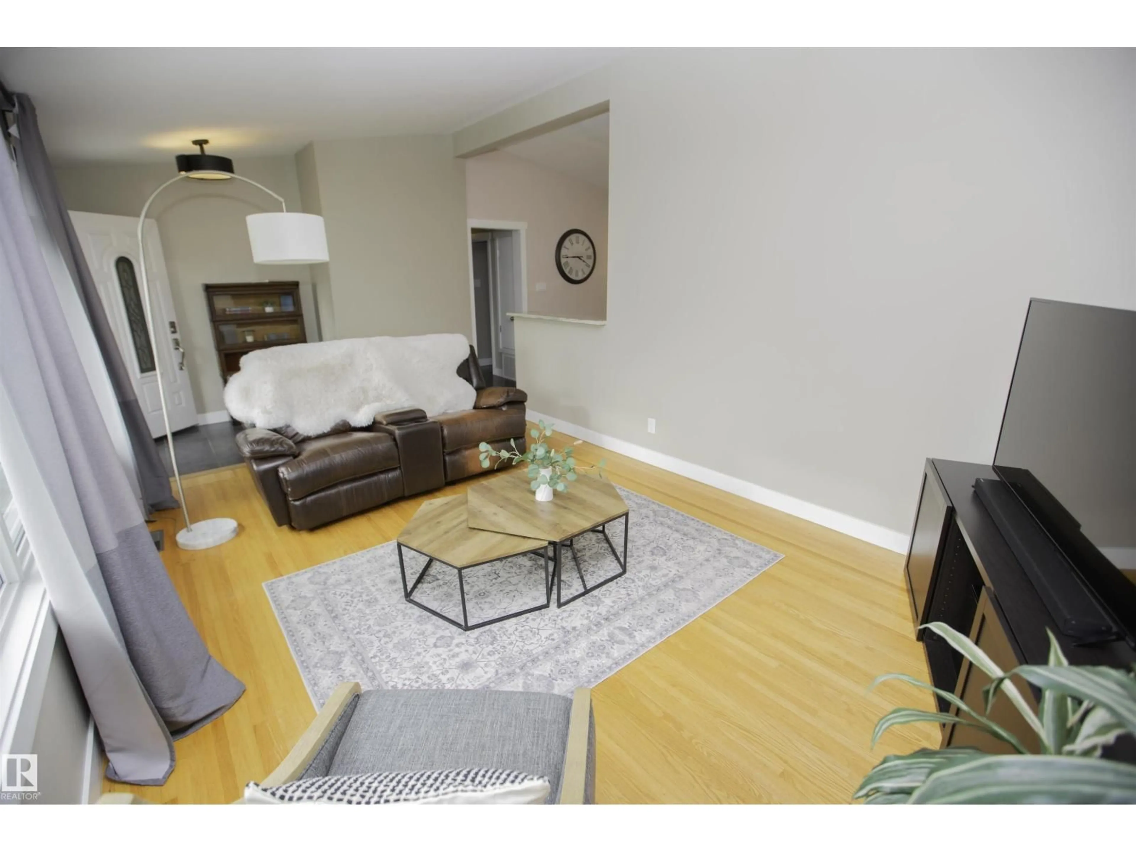 Living room with furniture, wood/laminate floor for 9107 58 ST, Edmonton Alberta T6B1L3