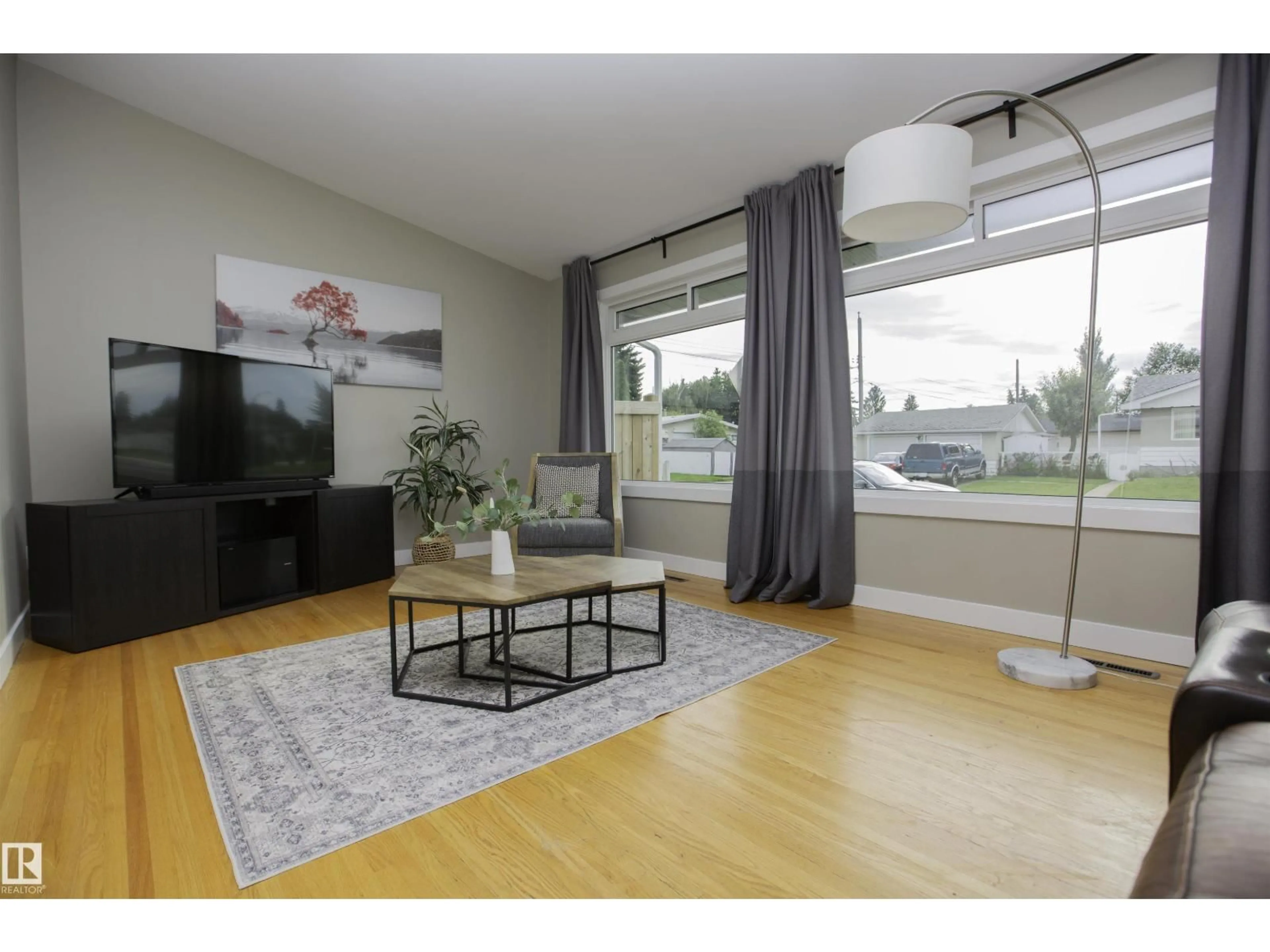 Living room with furniture, wood/laminate floor for 9107 58 ST, Edmonton Alberta T6B1L3