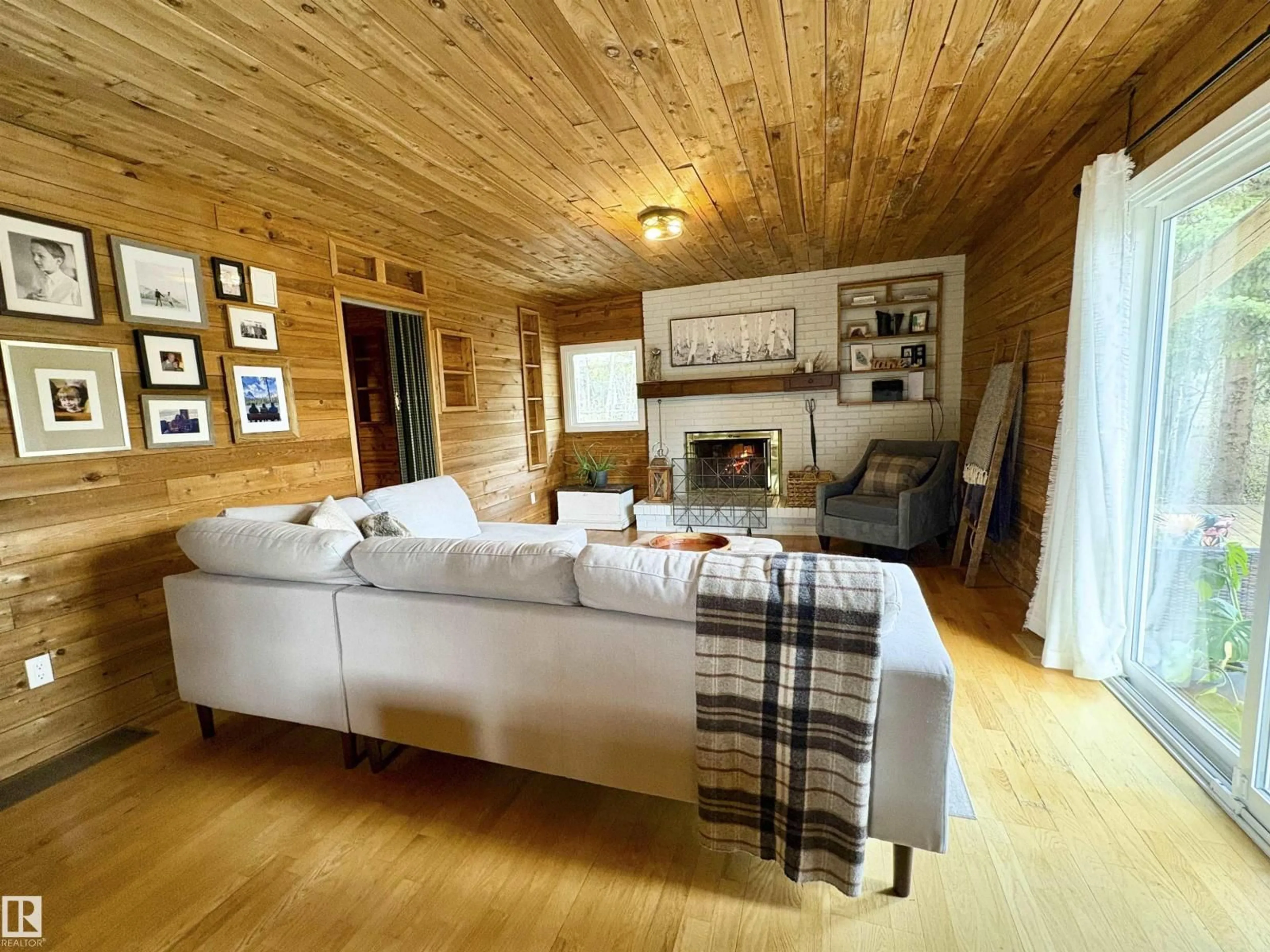Living room with furniture, wood/laminate floor for 1010 47402 RGE RD 13, Rural Leduc County Alberta T0C2P0