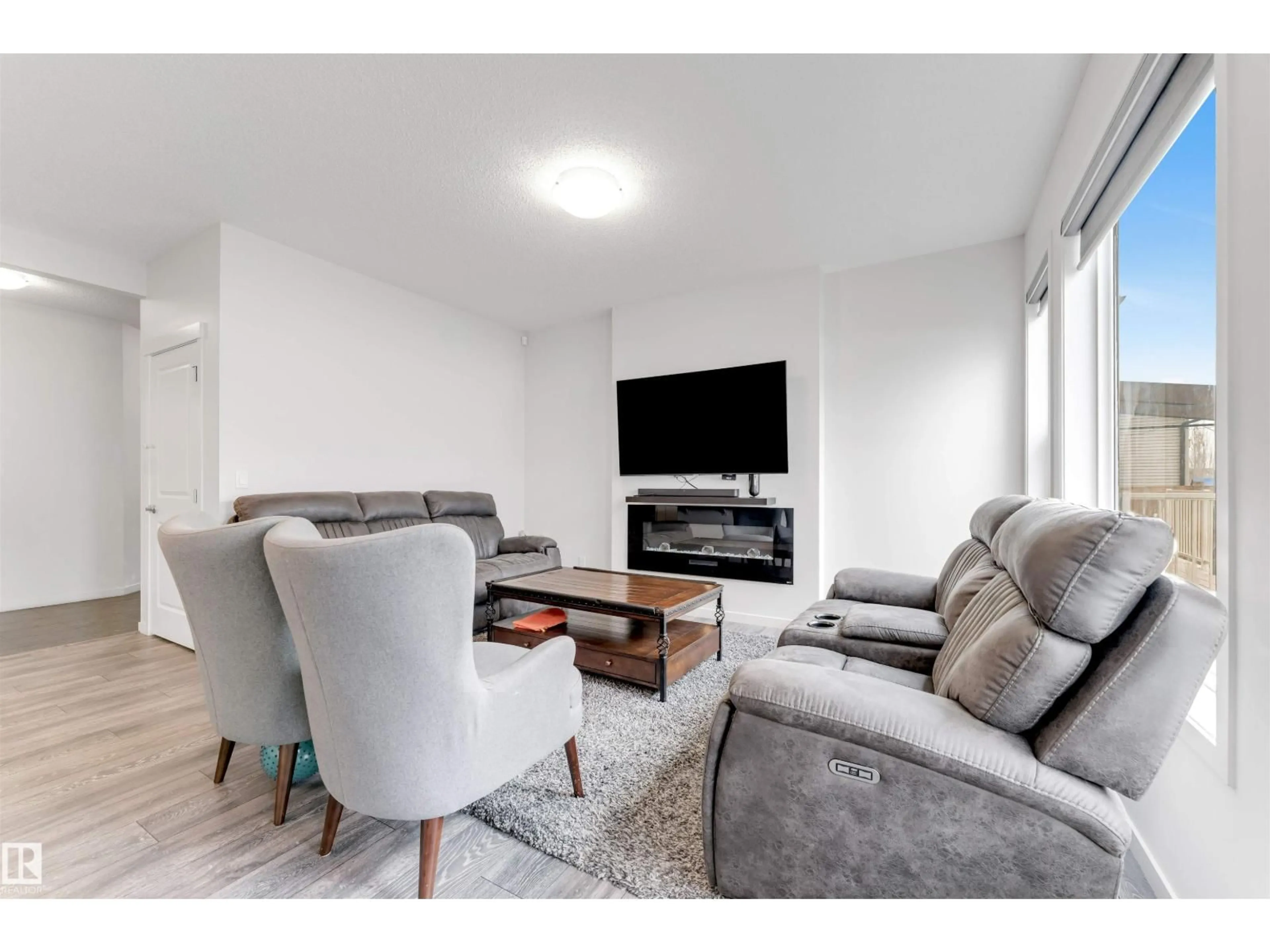 Living room with furniture, wood/laminate floor for 933 MCCONACHIE BV, Edmonton Alberta T5Y3X5