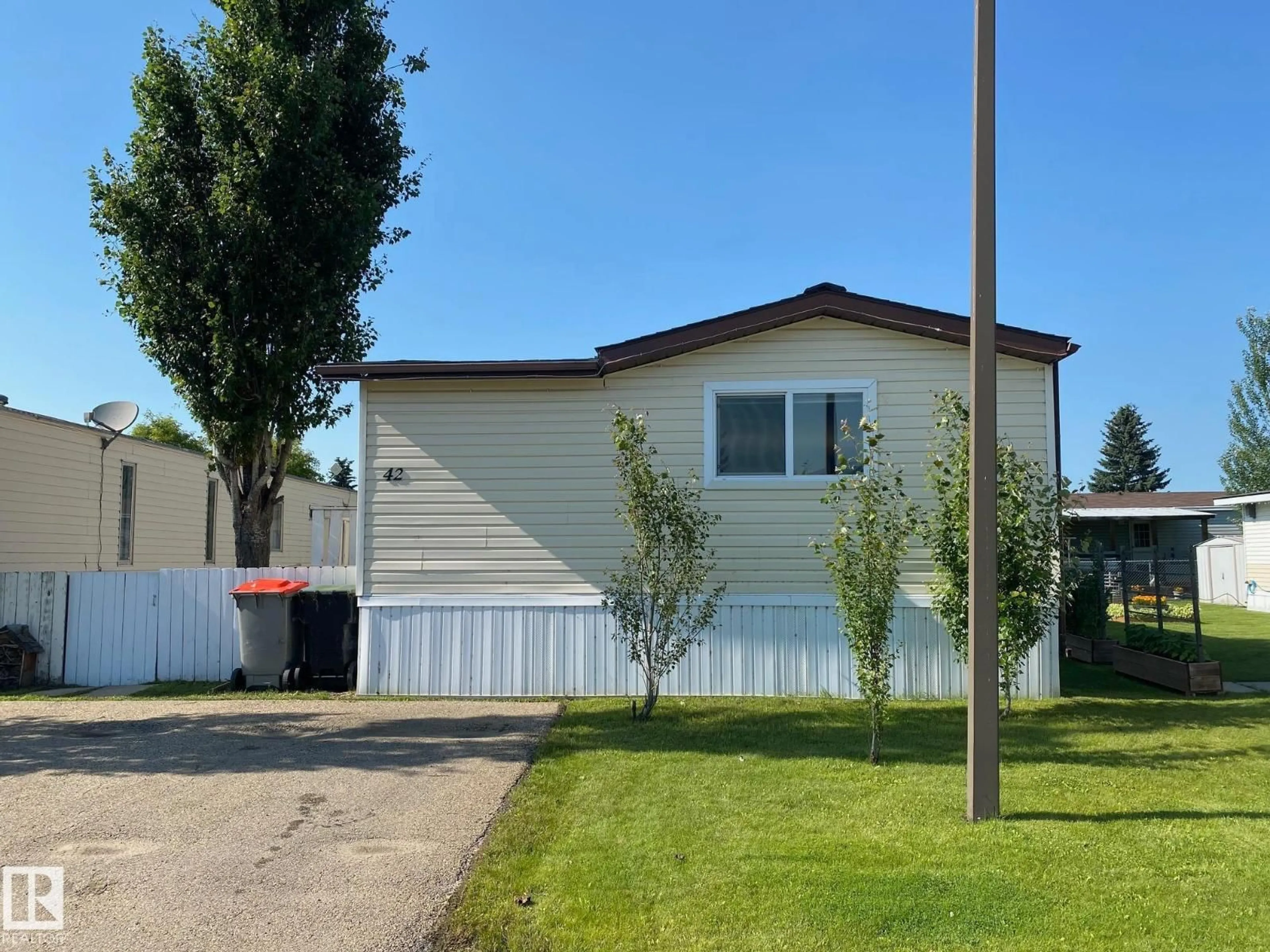 Home with vinyl exterior material, street for 042 - 4819 51 AV, Millet Alberta T0C1Z0