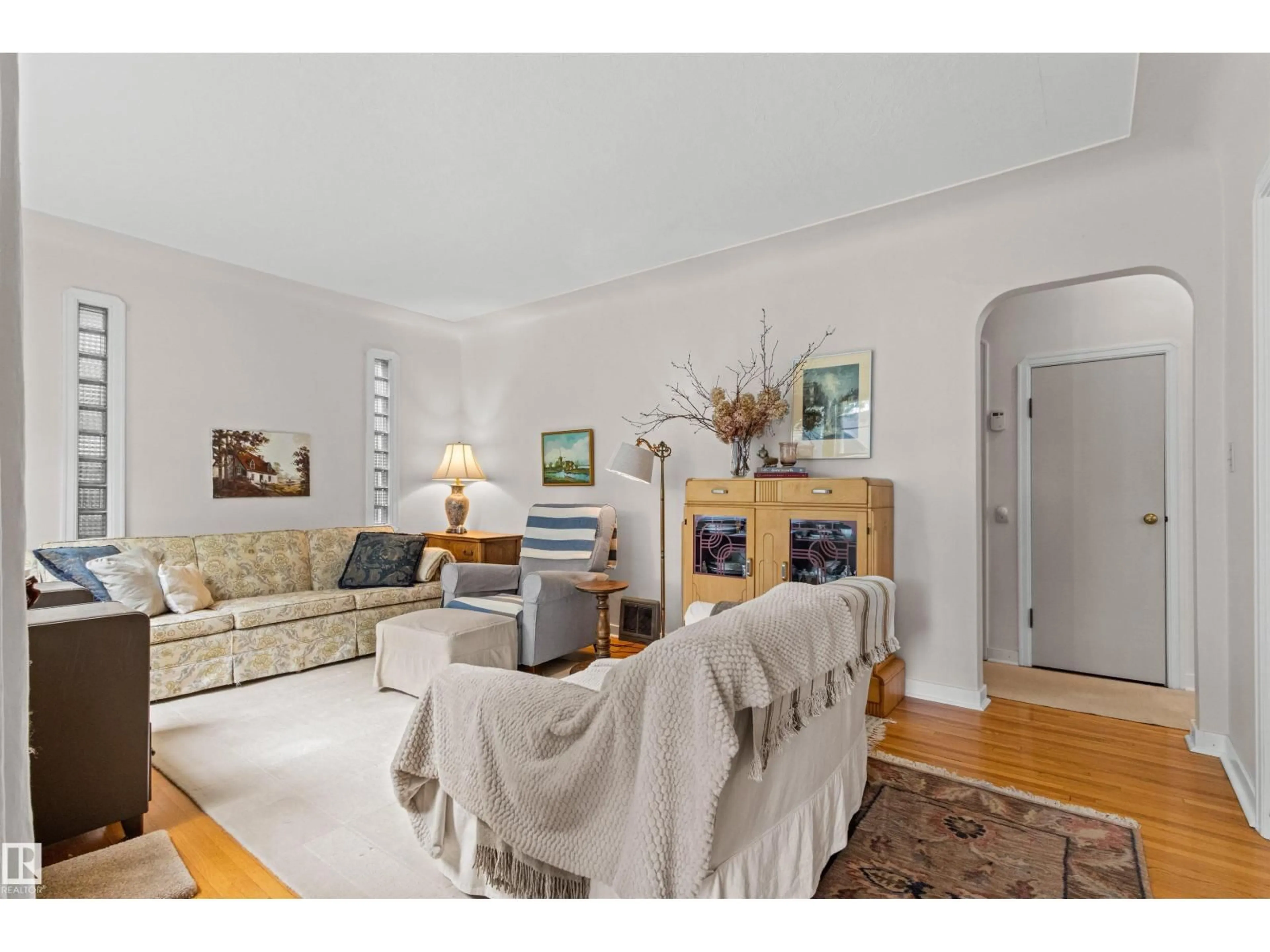 Living room with furniture, wood/laminate floor for 8842 89 ST, Edmonton Alberta T6C3K6