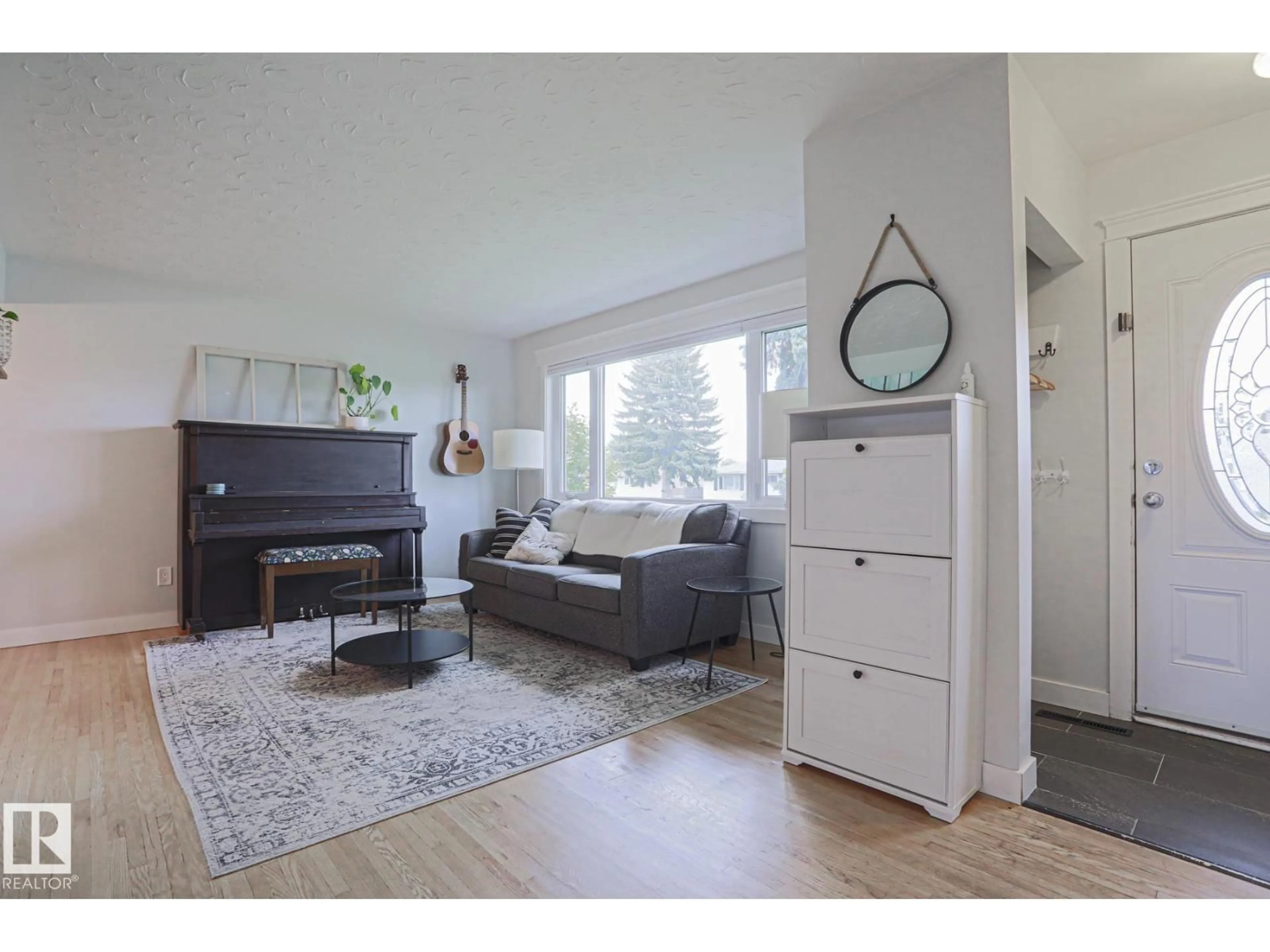 Living room with furniture, wood/laminate floor for 4640 102A AV, Edmonton Alberta T6A0R1