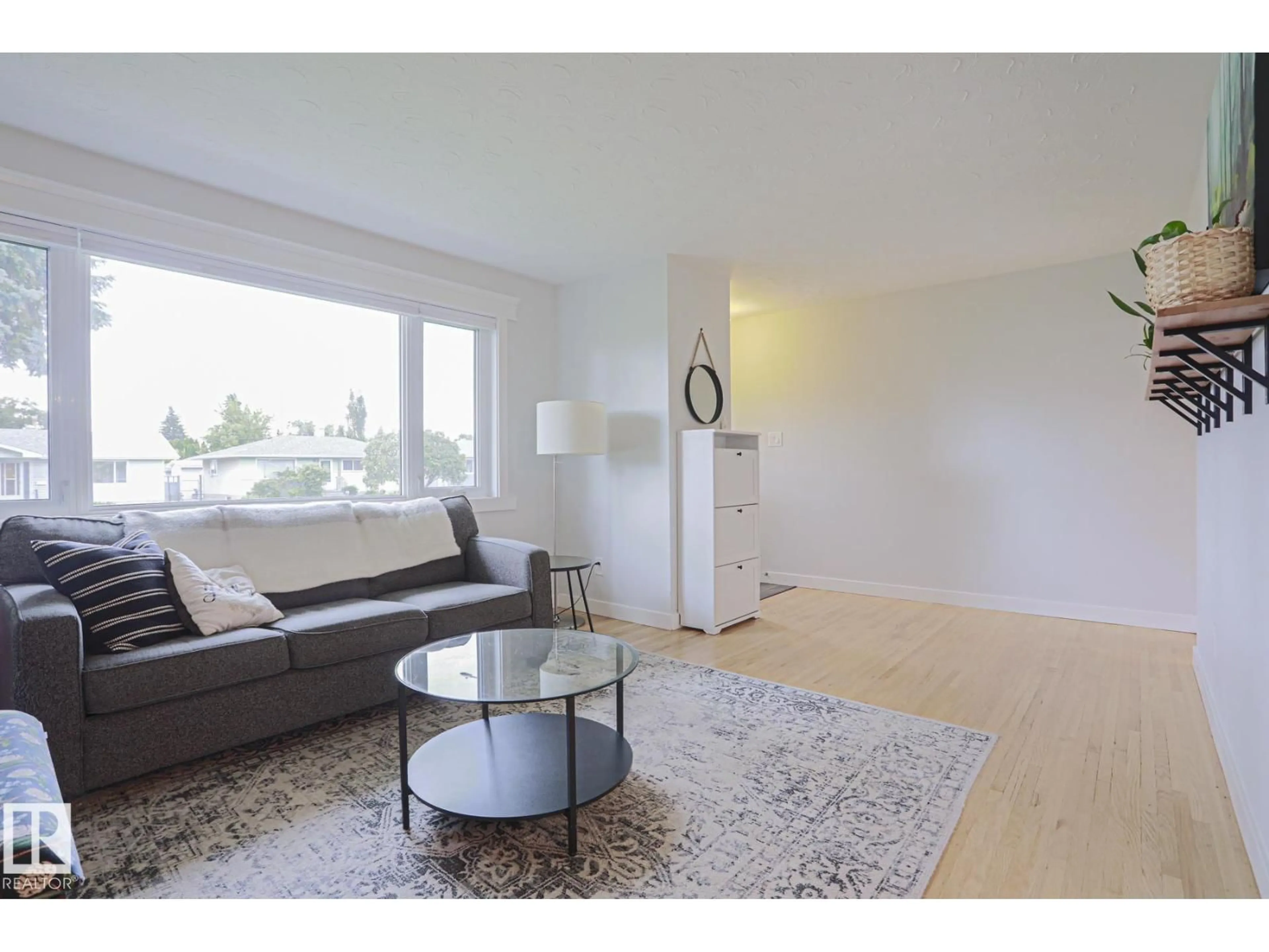 Living room with furniture, wood/laminate floor for 4640 102A AV, Edmonton Alberta T6A0R1
