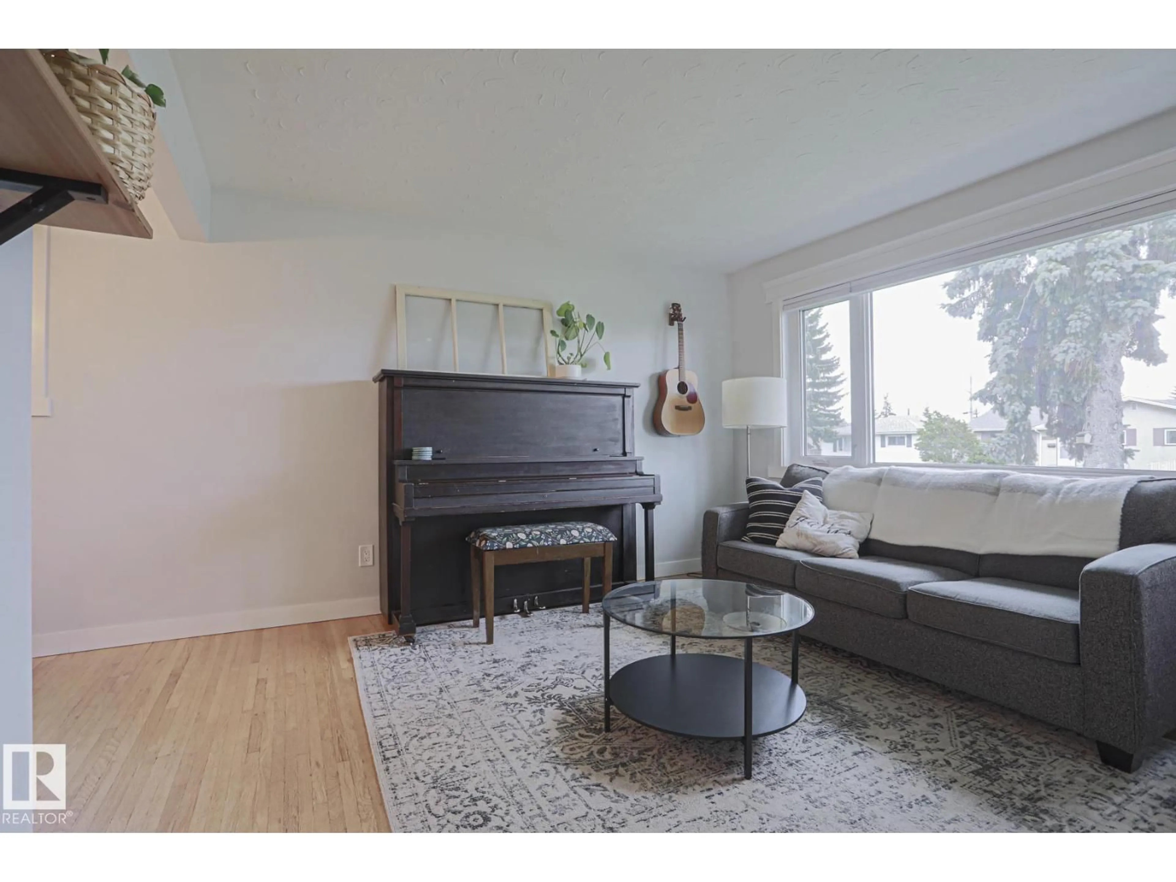 Living room with furniture, wood/laminate floor for 4640 102A AV, Edmonton Alberta T6A0R1