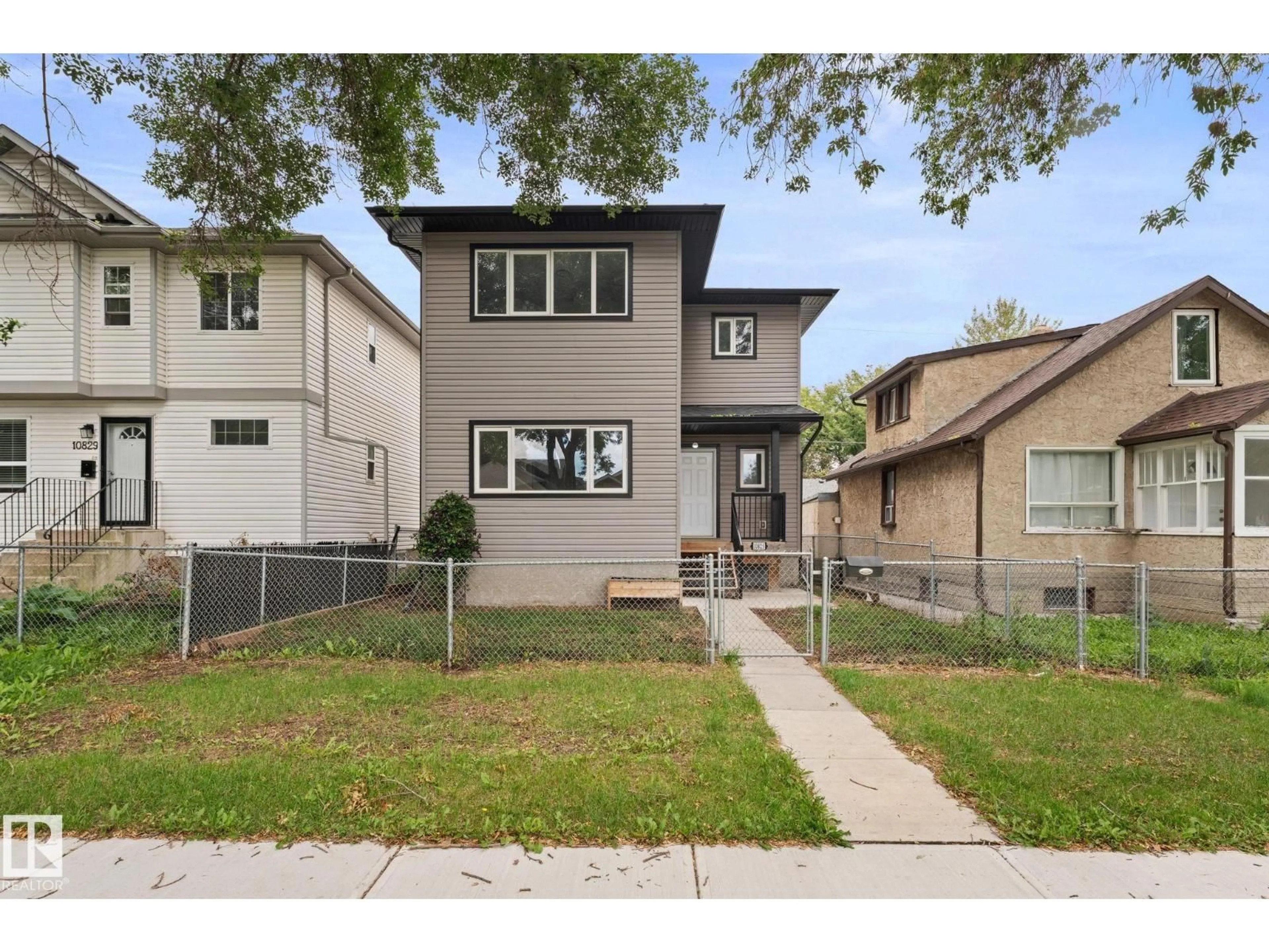 Home with vinyl exterior material, street for 10825 93 ST, Edmonton Alberta T5H1Y7