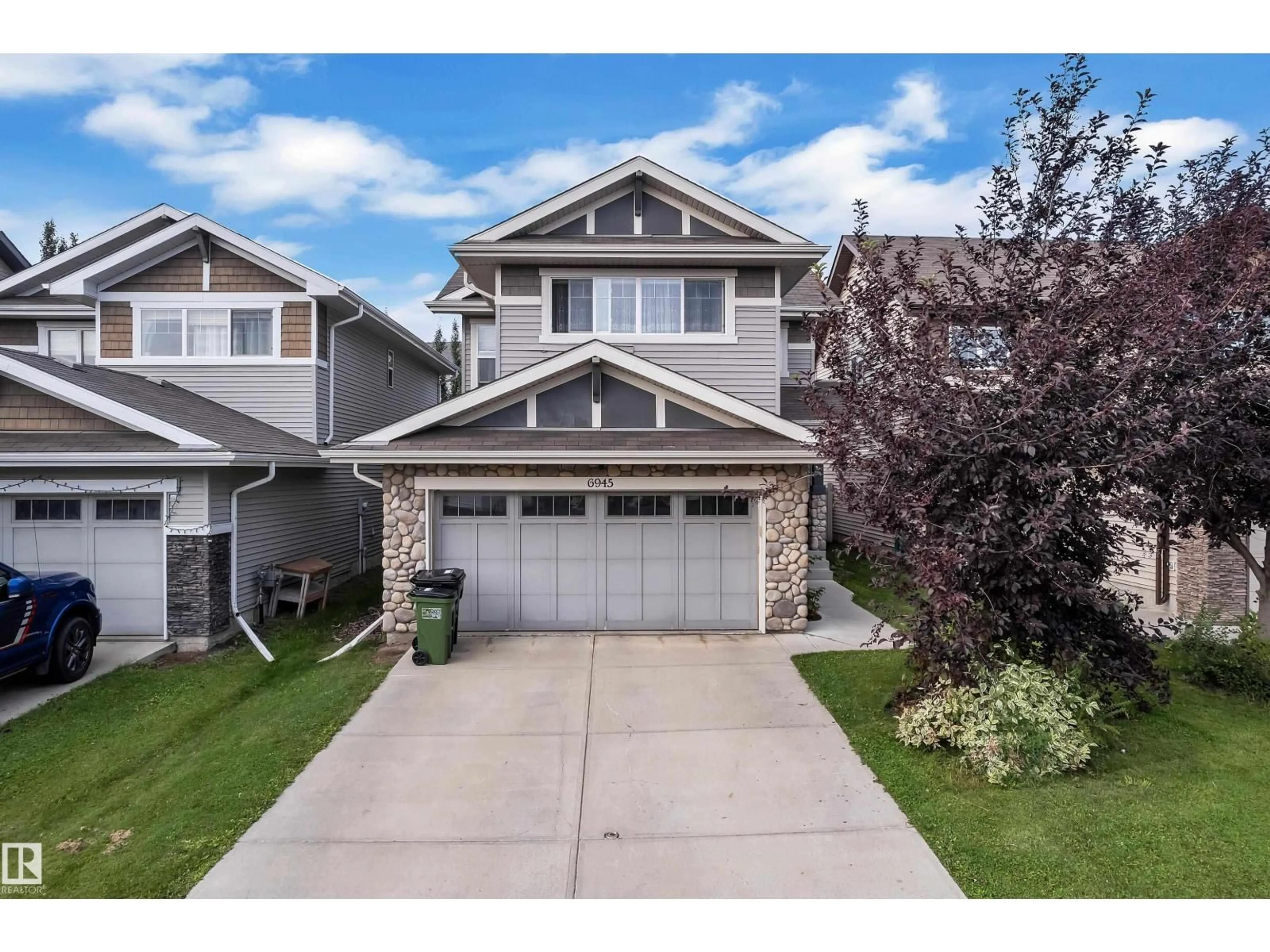 Home with vinyl exterior material, street for NW - 6945 EVANS WD, Edmonton Alberta T6M0P9