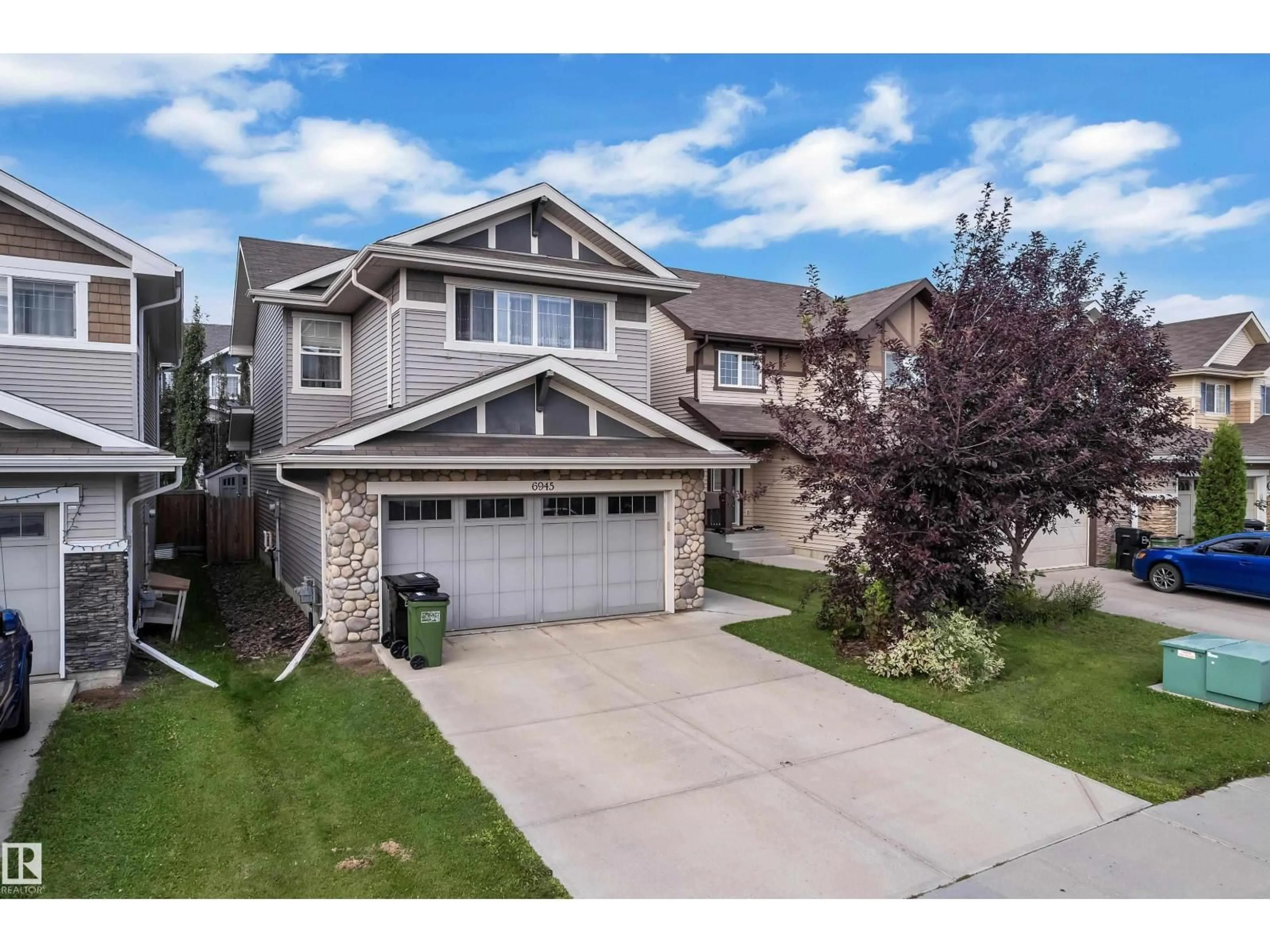 Home with vinyl exterior material, street for NW - 6945 EVANS WD, Edmonton Alberta T6M0P9