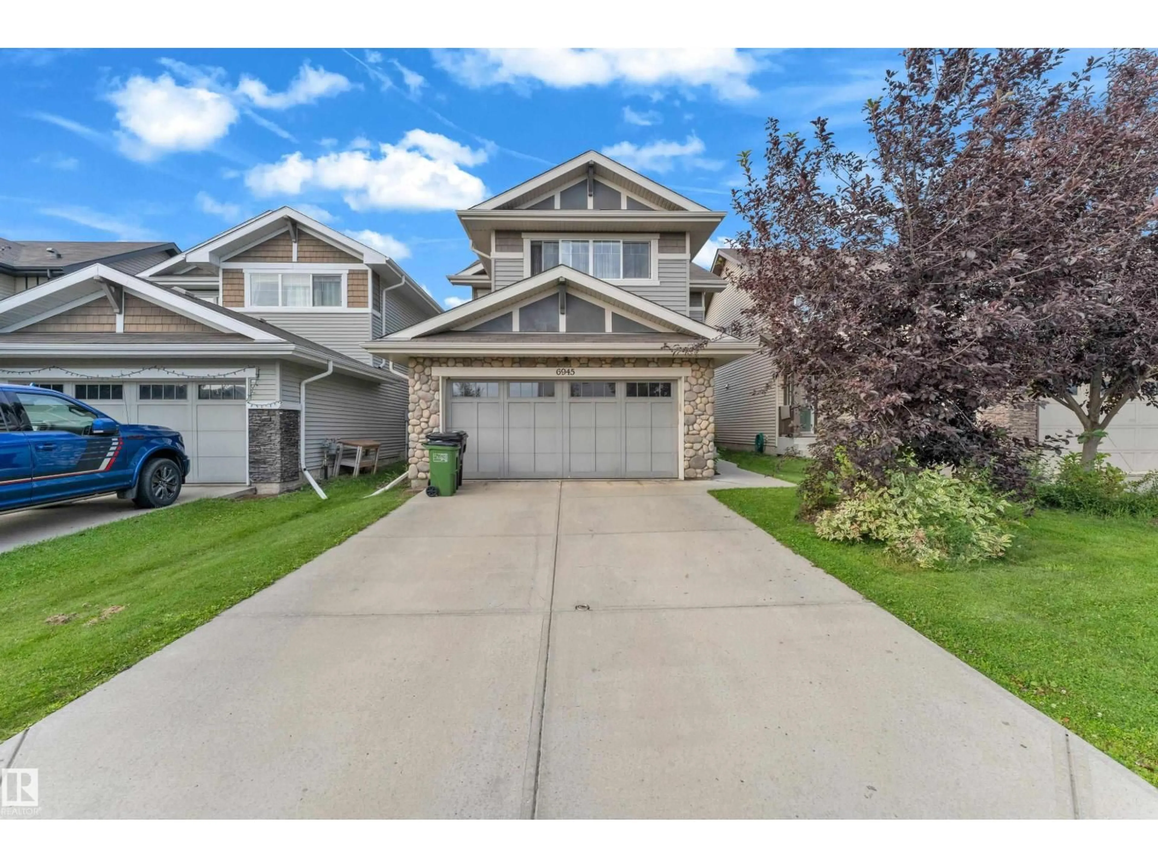 A pic from outside/outdoor area/front of a property/back of a property/a pic from drone, street for NW - 6945 EVANS WD, Edmonton Alberta T6M0P9