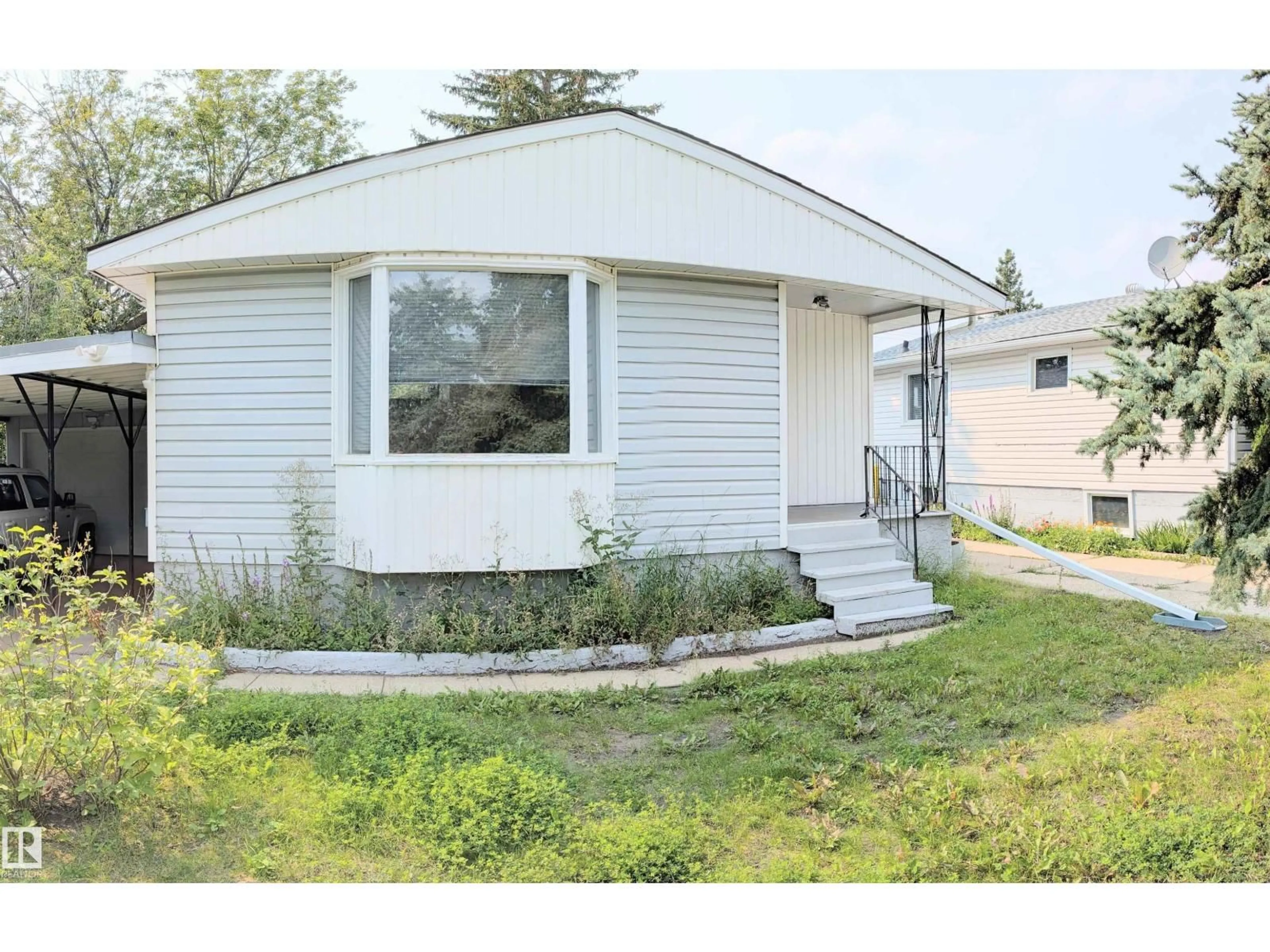 Home with vinyl exterior material, street for NW - 9712 162 ST, Edmonton Alberta T5P3K9