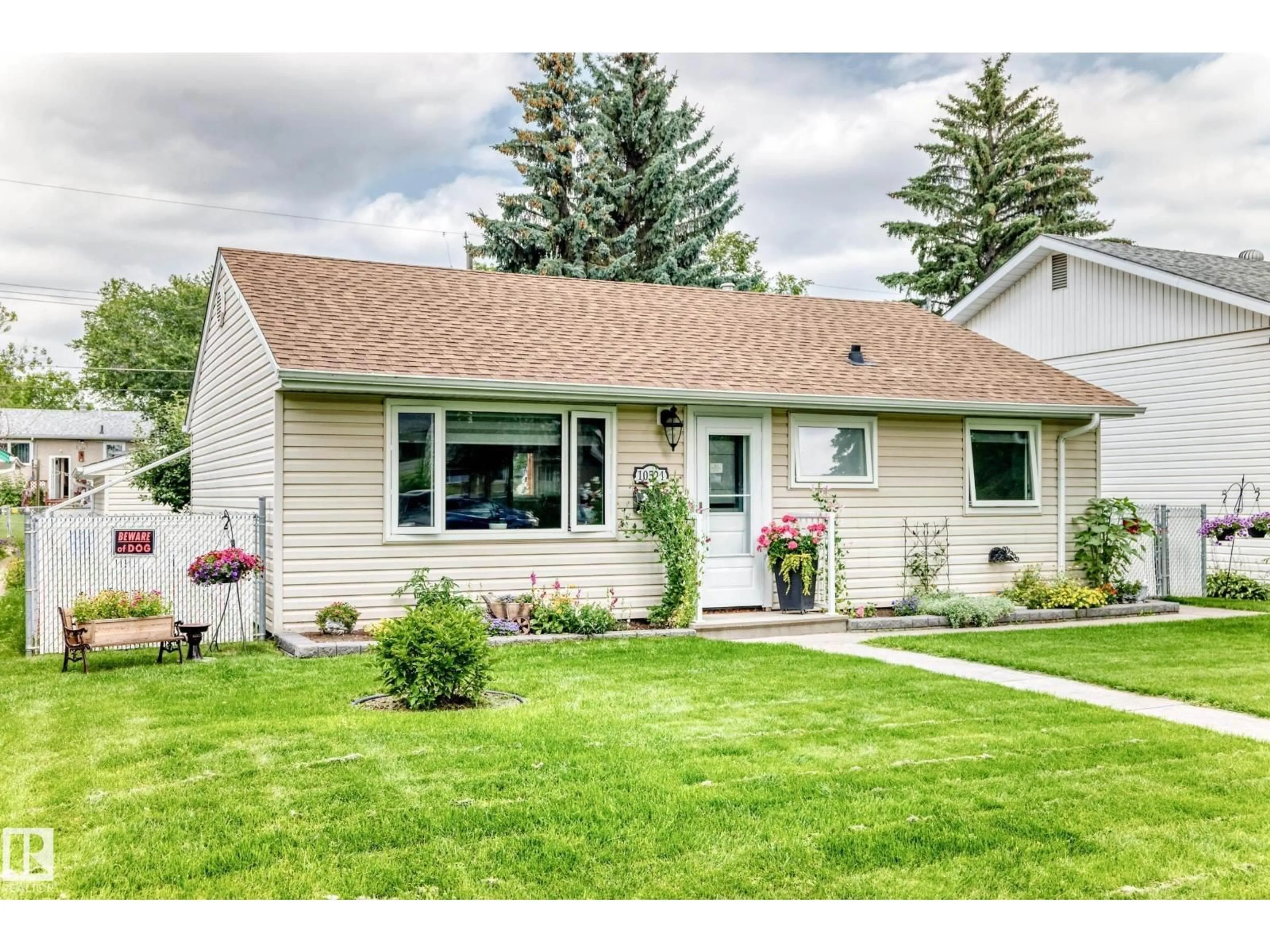 Home with vinyl exterior material, street for 10524 128 AV, Edmonton Alberta T5E0J3
