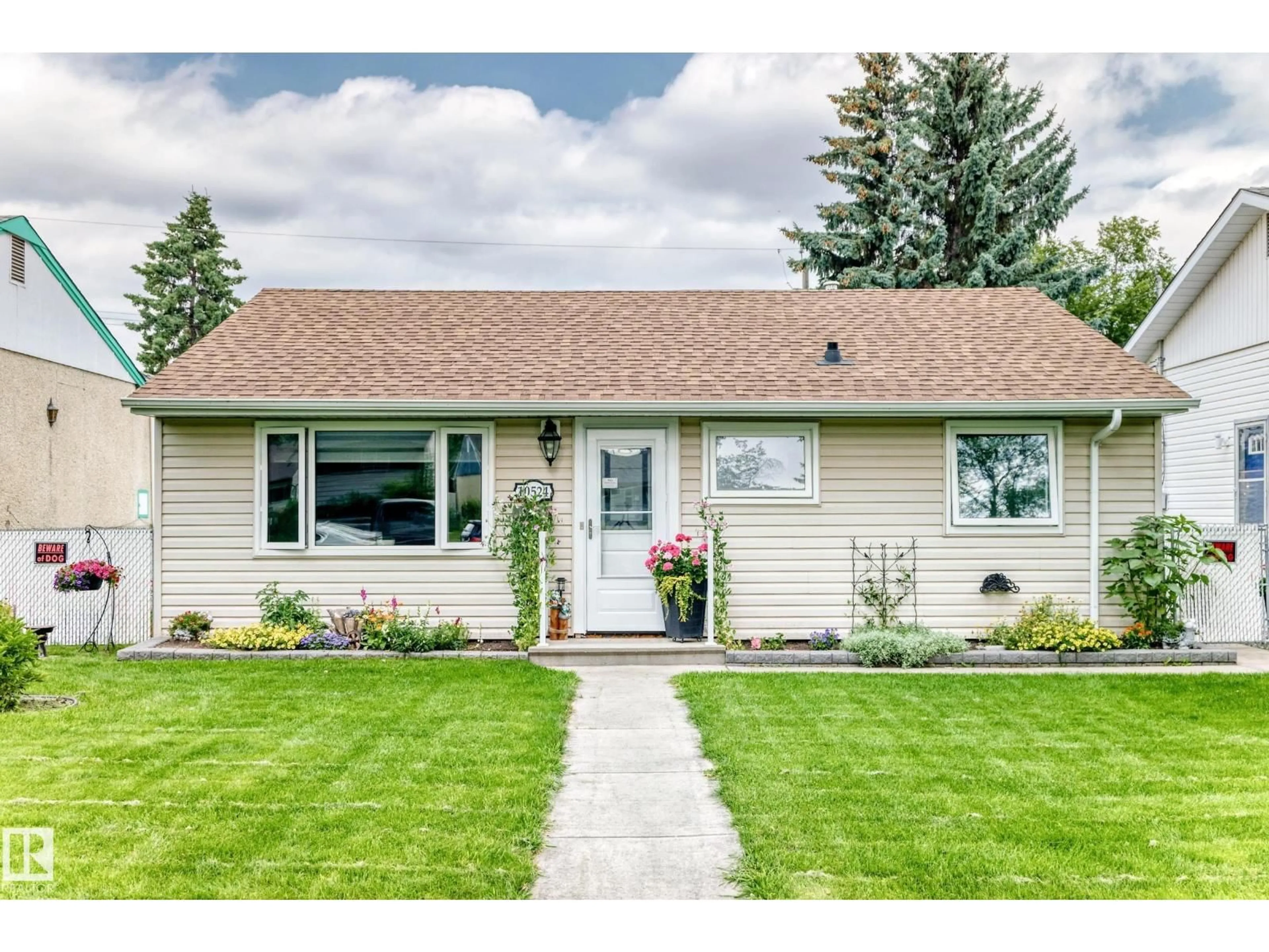Home with vinyl exterior material, street for 10524 128 AV, Edmonton Alberta T5E0J3