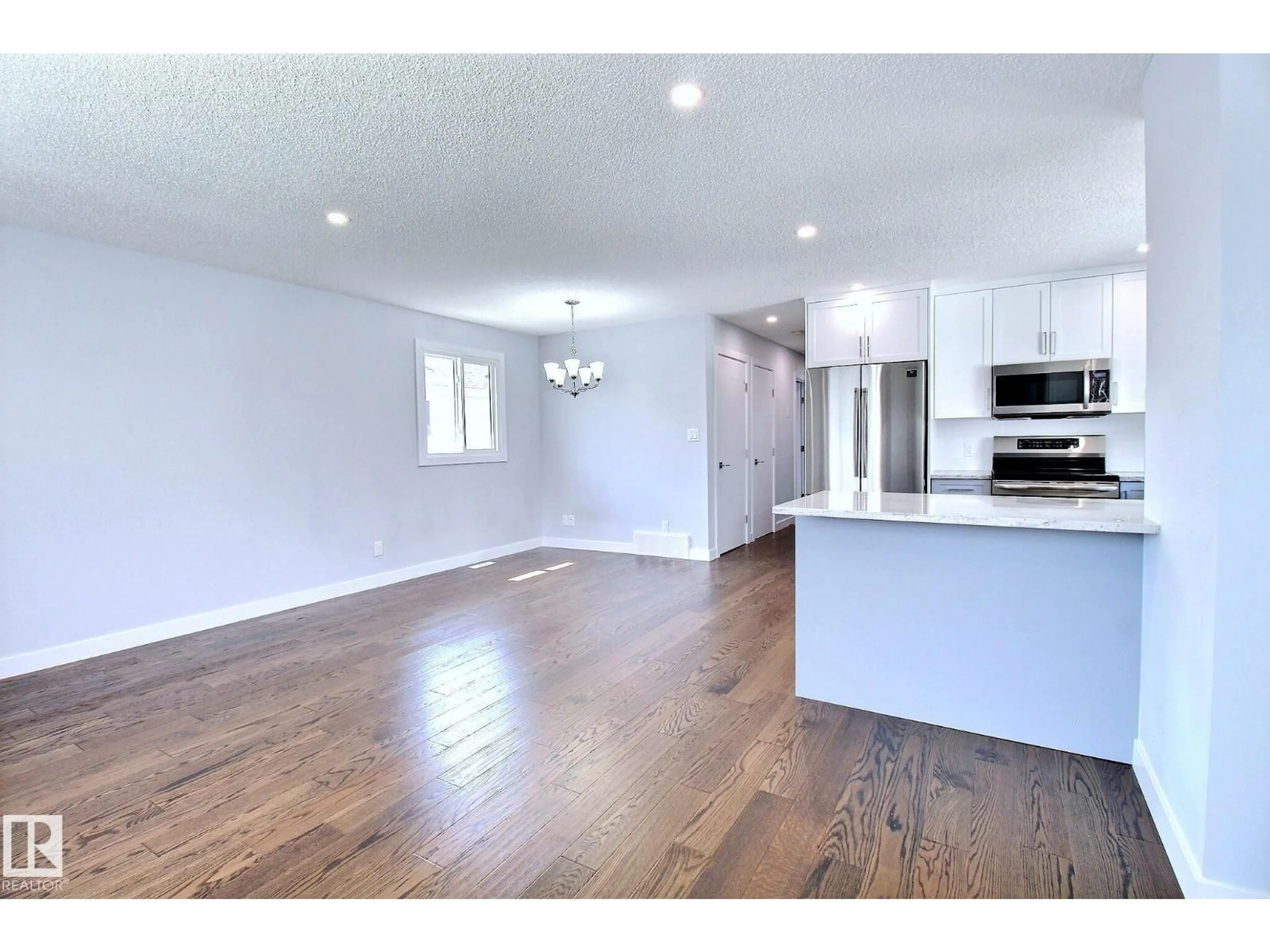 Open concept kitchen, wood/laminate floor for NW - 14732 32 ST, Edmonton Alberta T5Y2G3