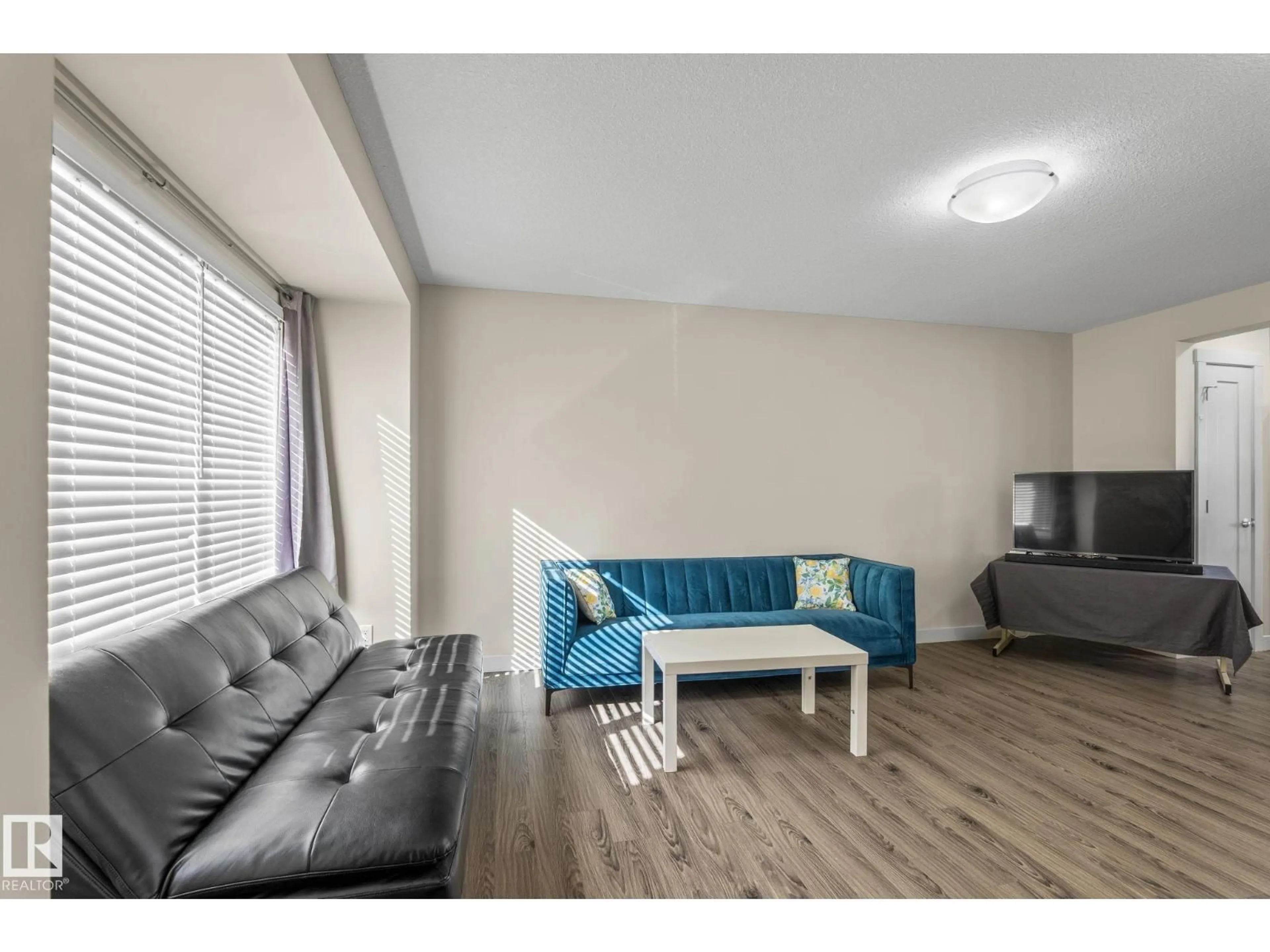 Living room with furniture, wood/laminate floor for #24 - 4205 30 ST, Edmonton Alberta T6T2G9