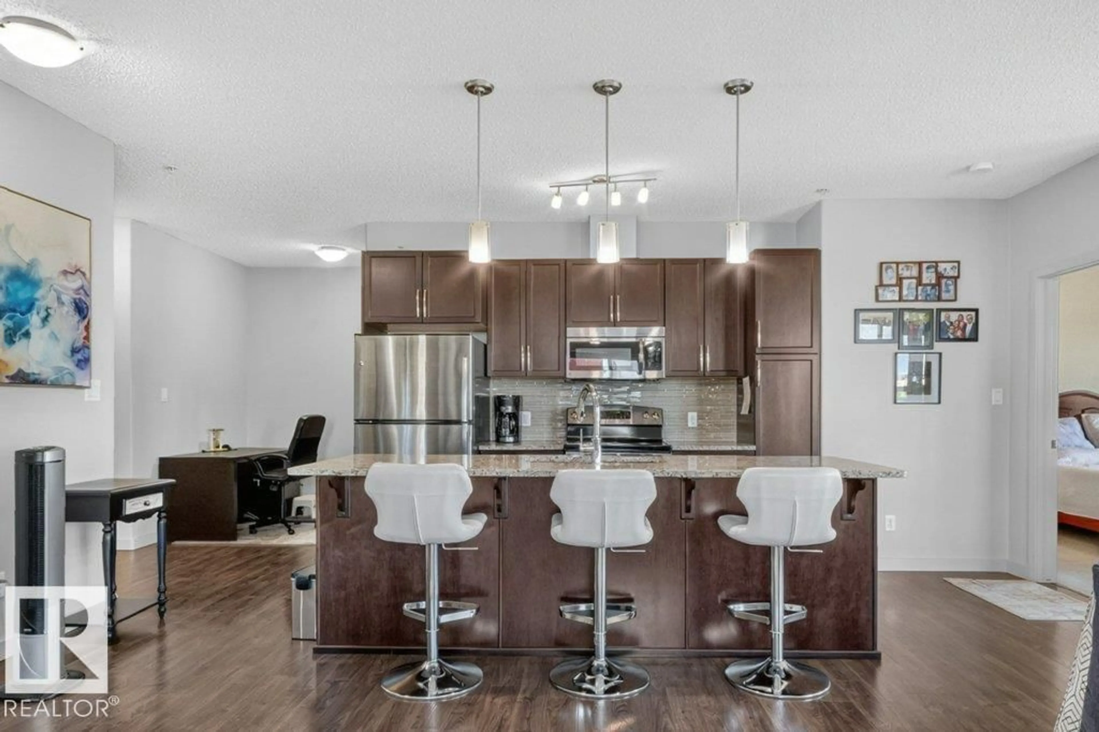 Open concept kitchen, wood/laminate floor for 320 - 423 AMBLESIDE LI, Edmonton Alberta T6W2Z9