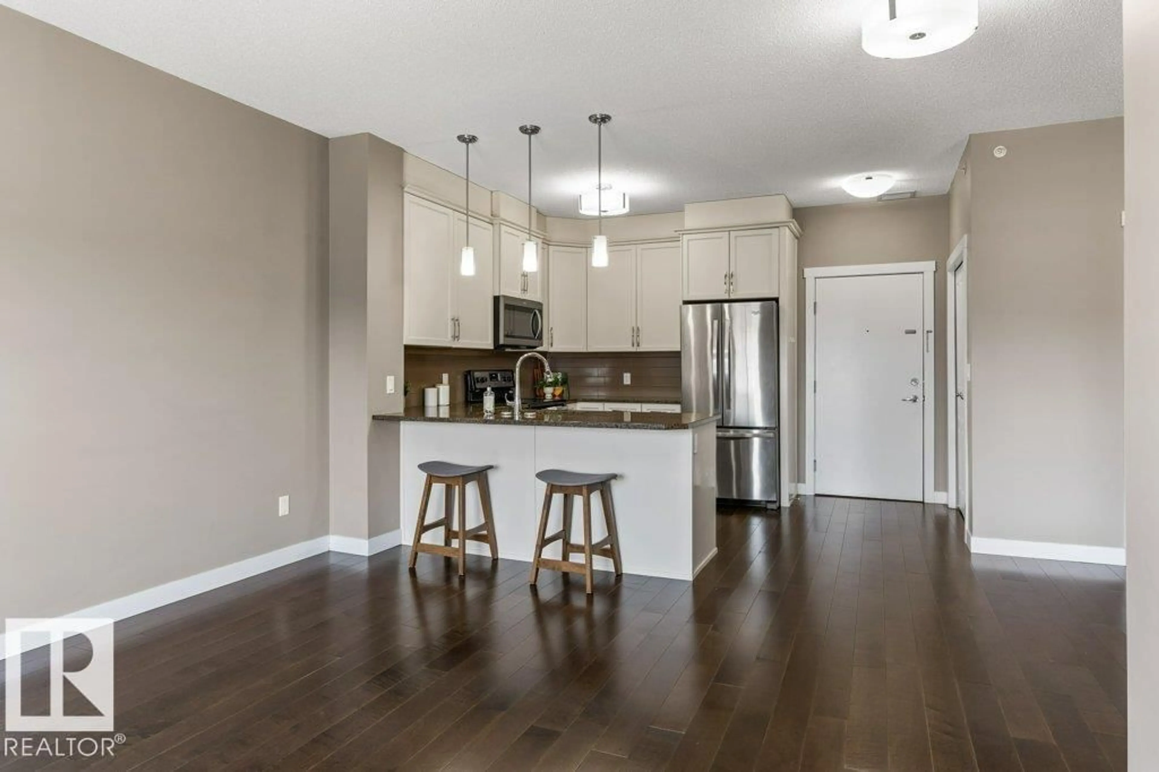 Open concept kitchen, wood/laminate floor for 409 - 2207 44 AV NW, Edmonton Alberta T6T0T2
