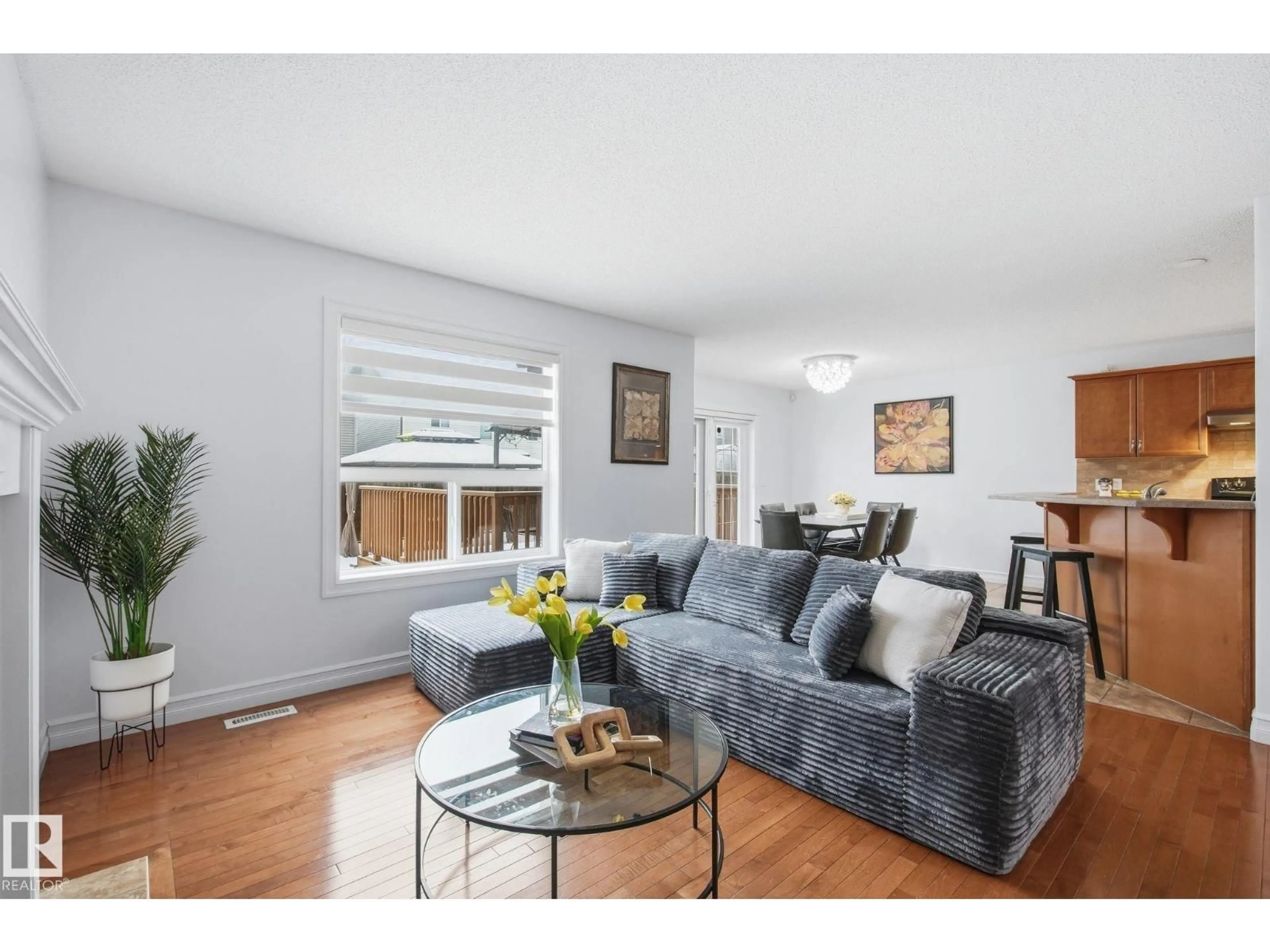 Living room with furniture, wood/laminate floor for 3016 24 AVE NW, Edmonton Alberta T6T0G7