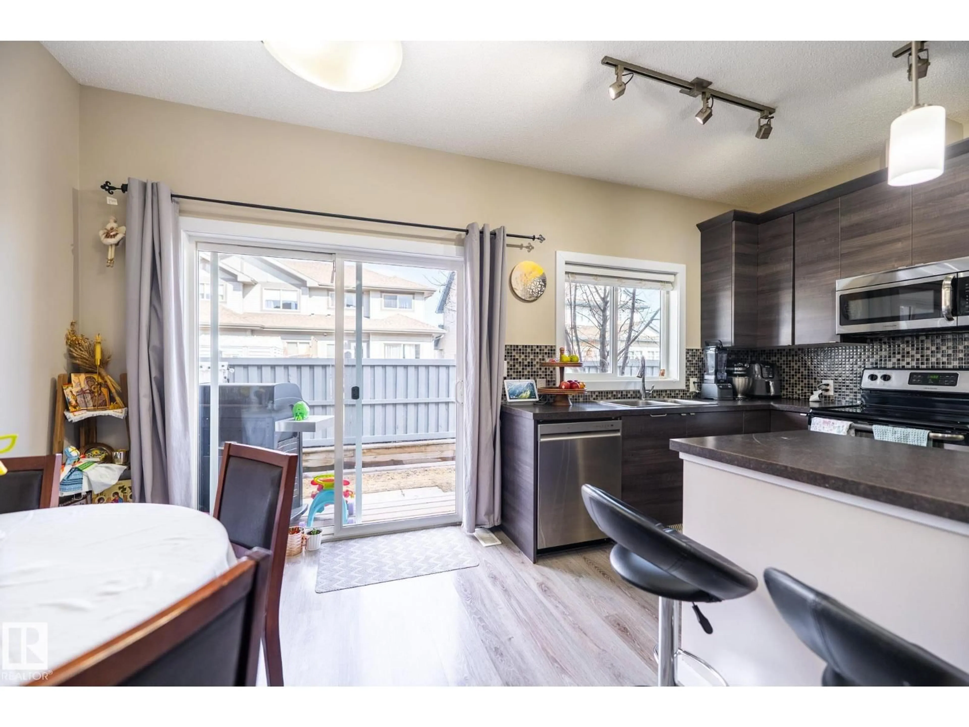 Open concept kitchen, wood/laminate floor for #4 - 3710 ALLAN DR, Edmonton Alberta T6W2C4