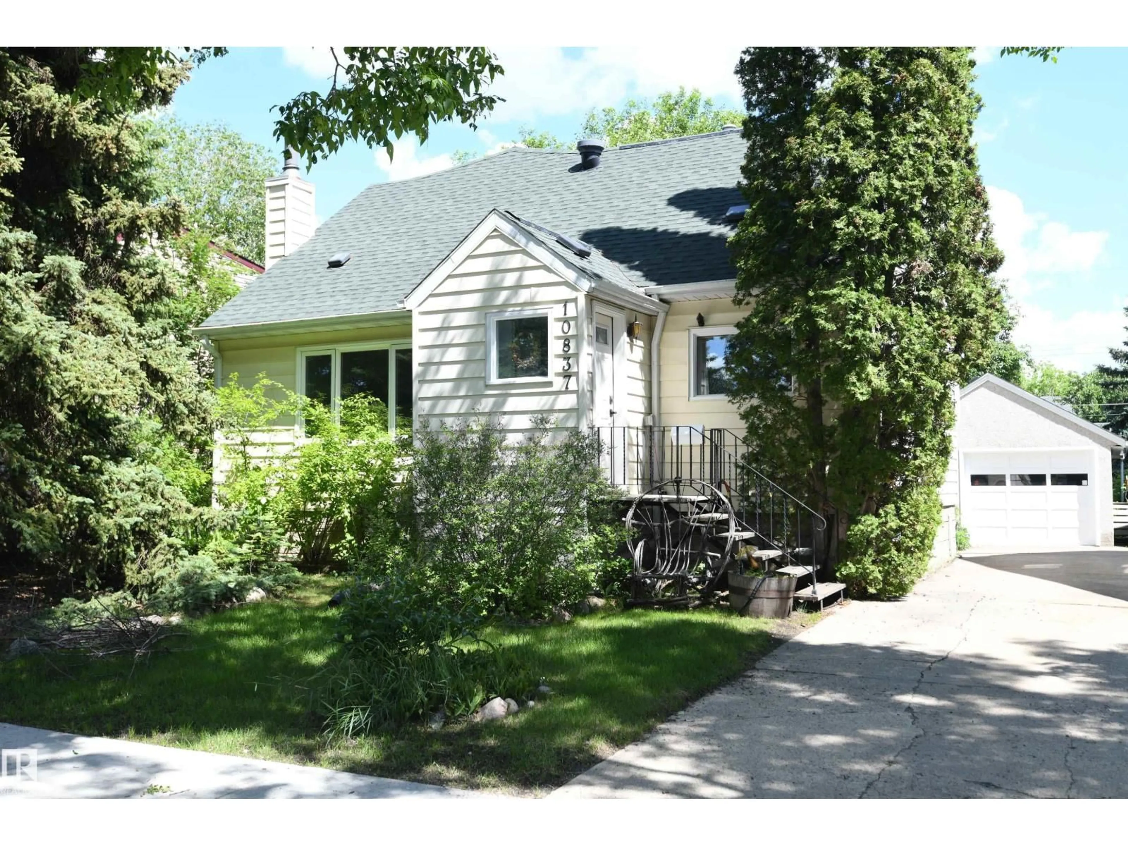 Home with vinyl exterior material, street for NW - 10837 139 ST, Edmonton Alberta T5M1P6