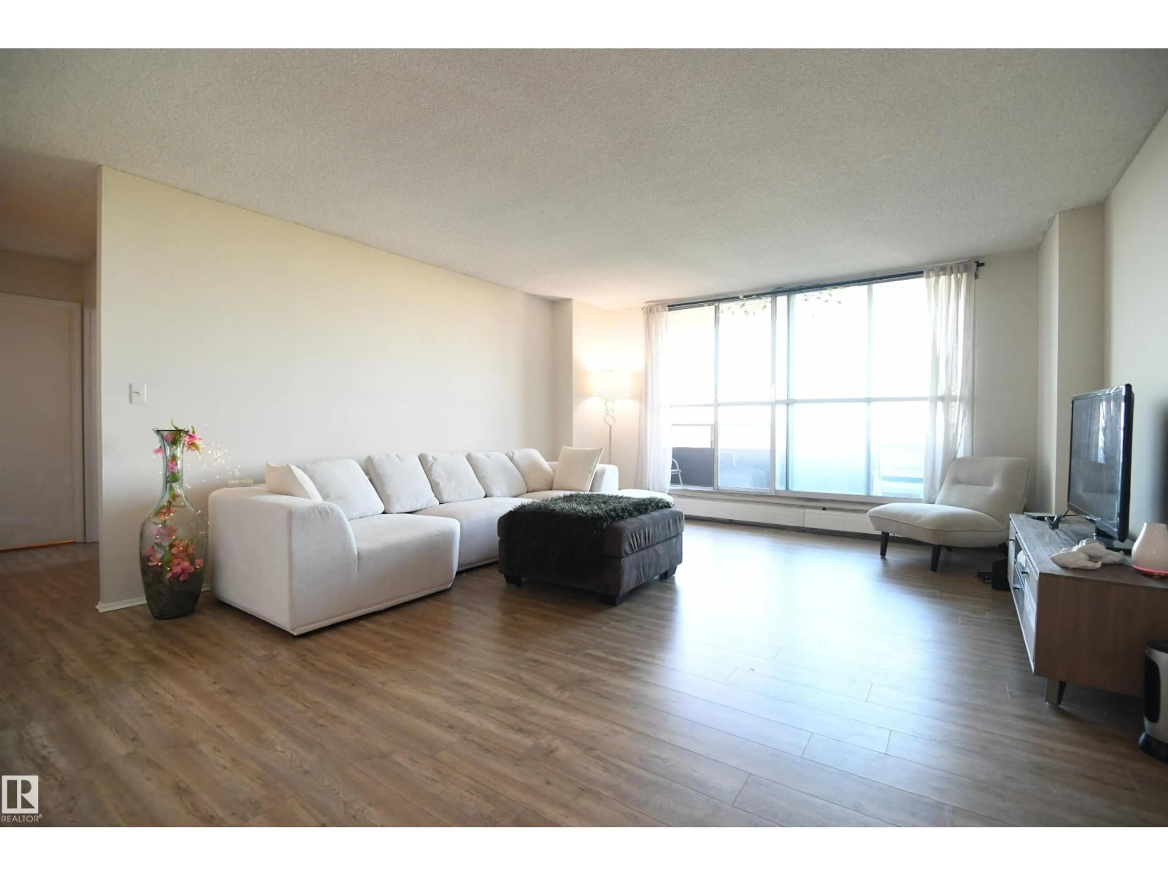 Living room with furniture, wood/laminate floor for 1305 STONY PLAIN RD, Edmonton Alberta T5N3R2
