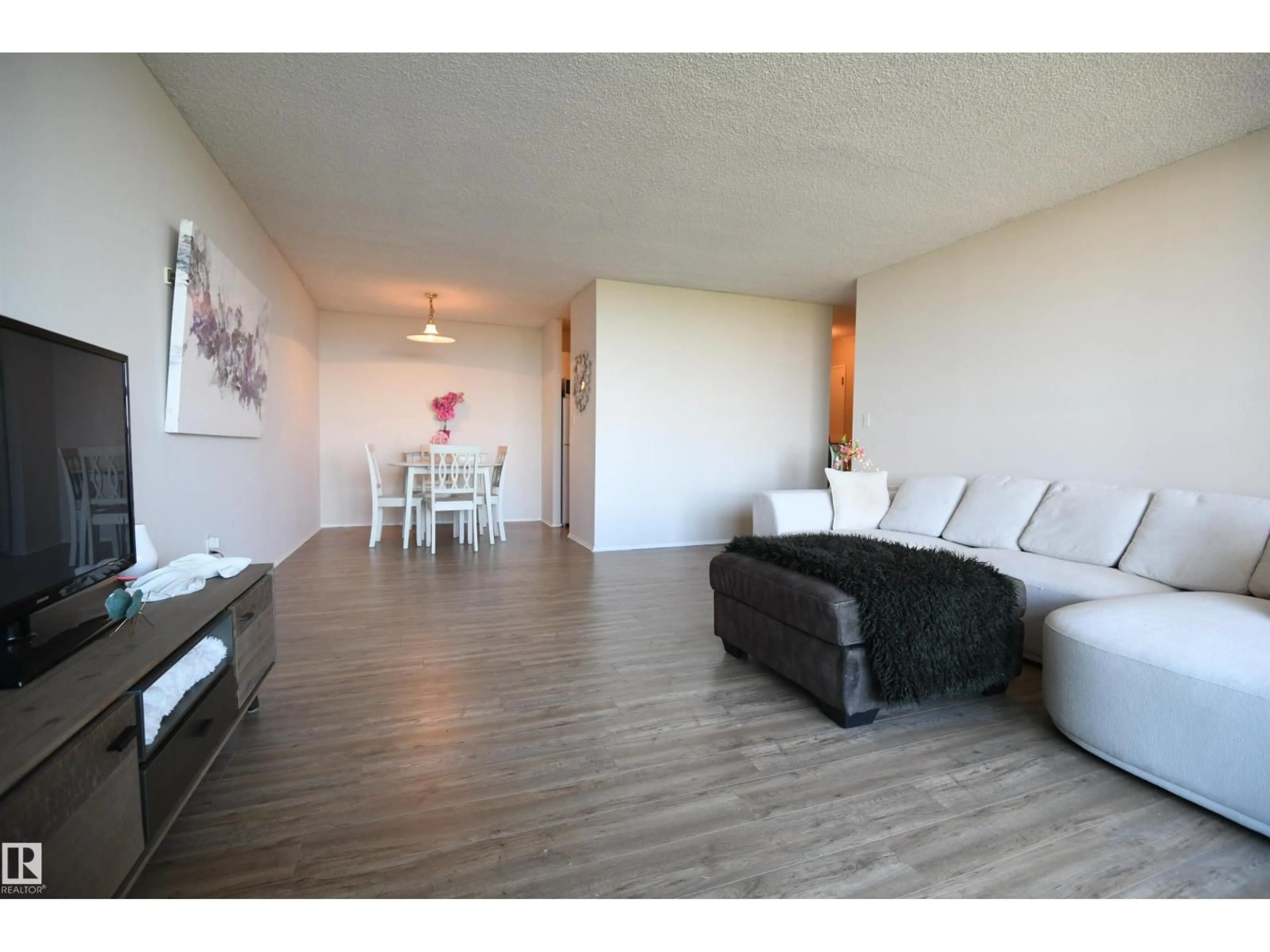 Living room with furniture, wood/laminate floor for 1305 STONY PLAIN RD, Edmonton Alberta T5N3R2