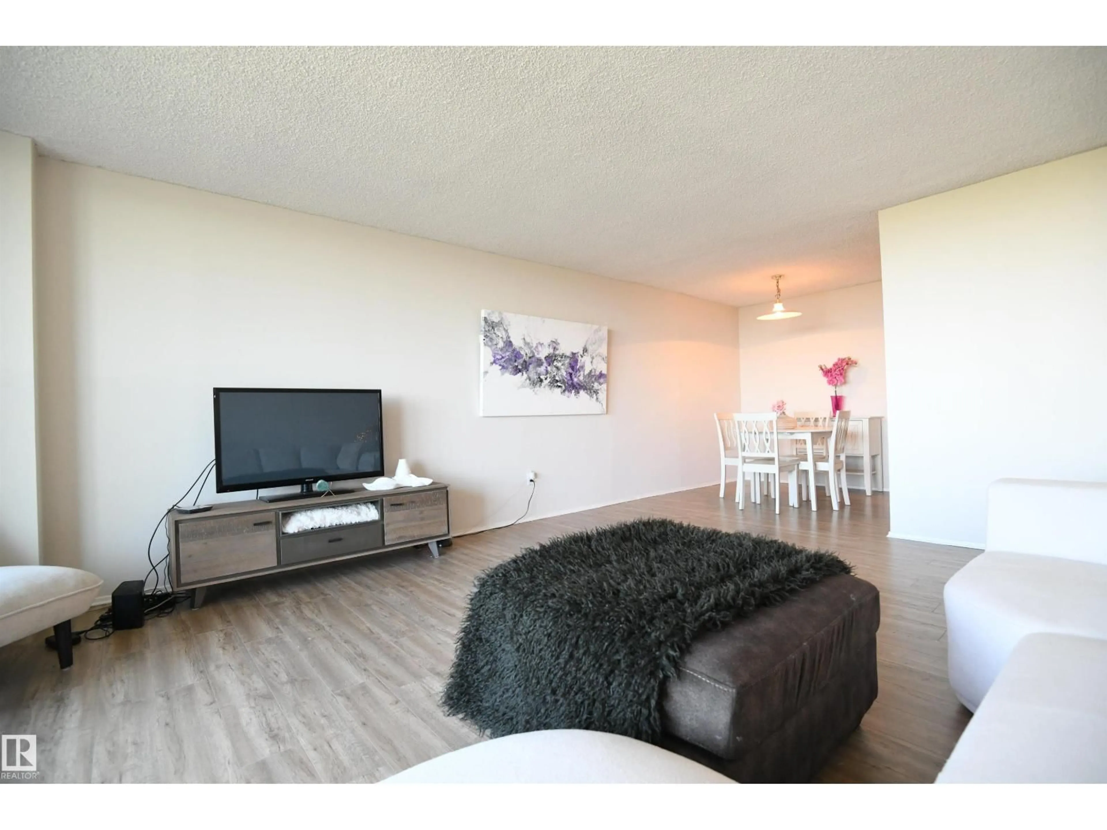 Living room with furniture, wood/laminate floor for 1305 STONY PLAIN RD, Edmonton Alberta T5N3R2