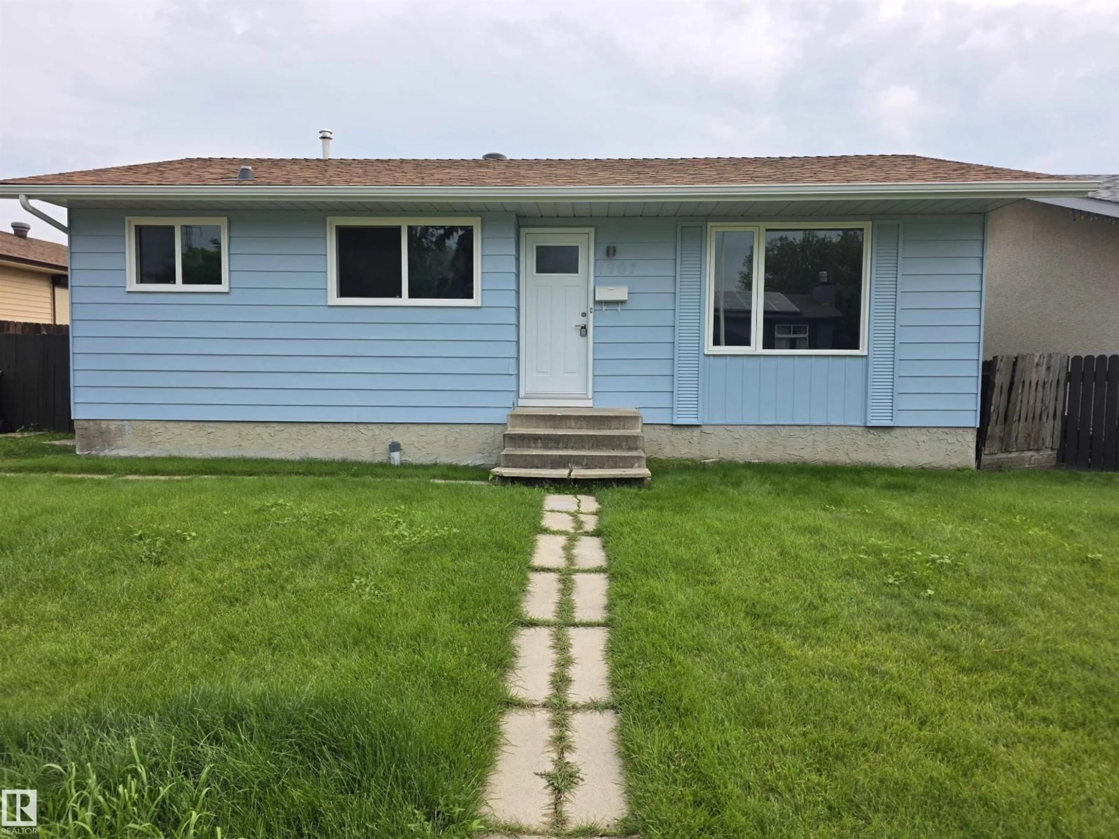 Home with vinyl exterior material, street for 1907 145A AV, Edmonton Alberta T5Y1S9