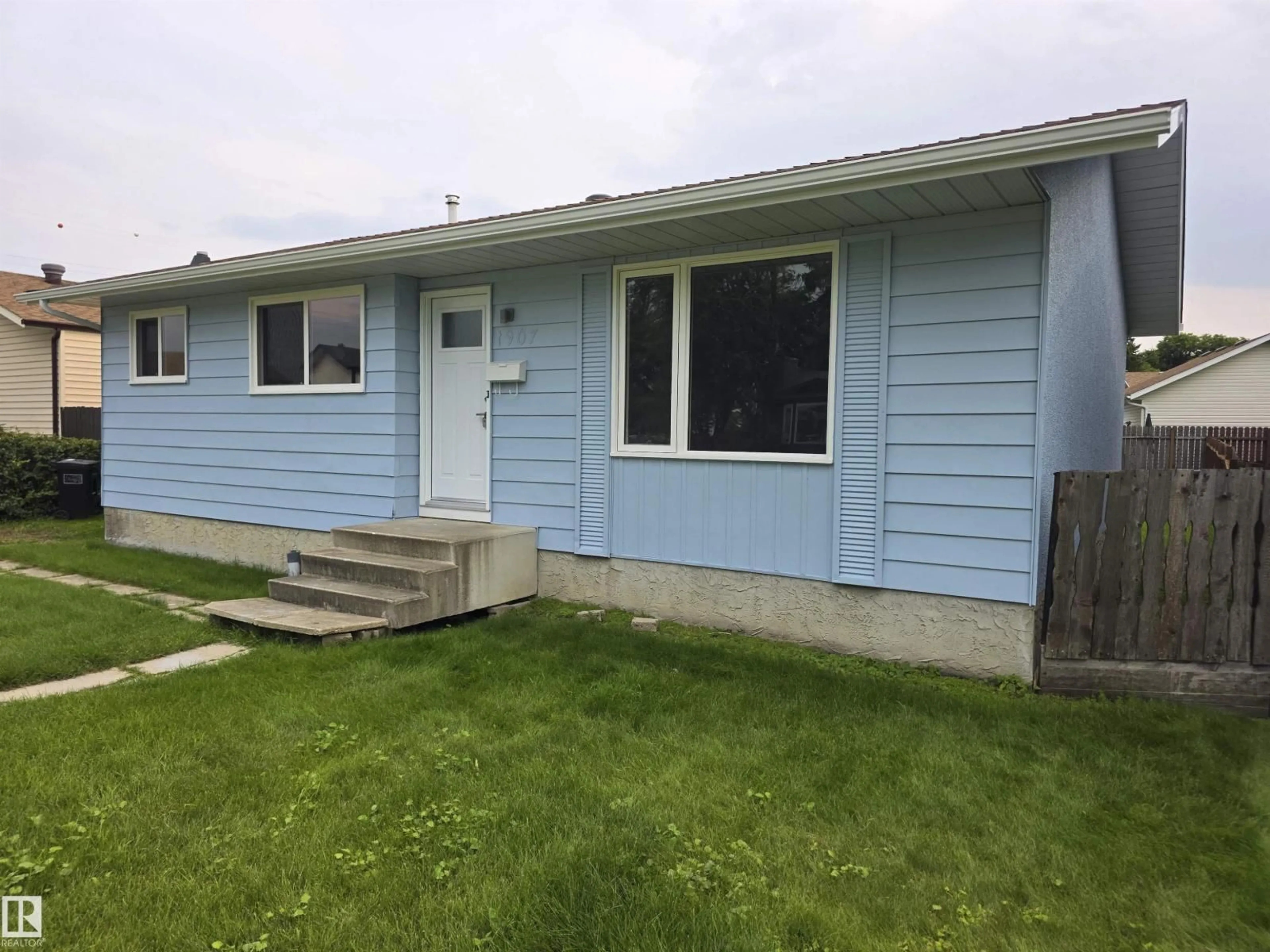 Home with vinyl exterior material, street for 1907 145A AV, Edmonton Alberta T5Y1S9