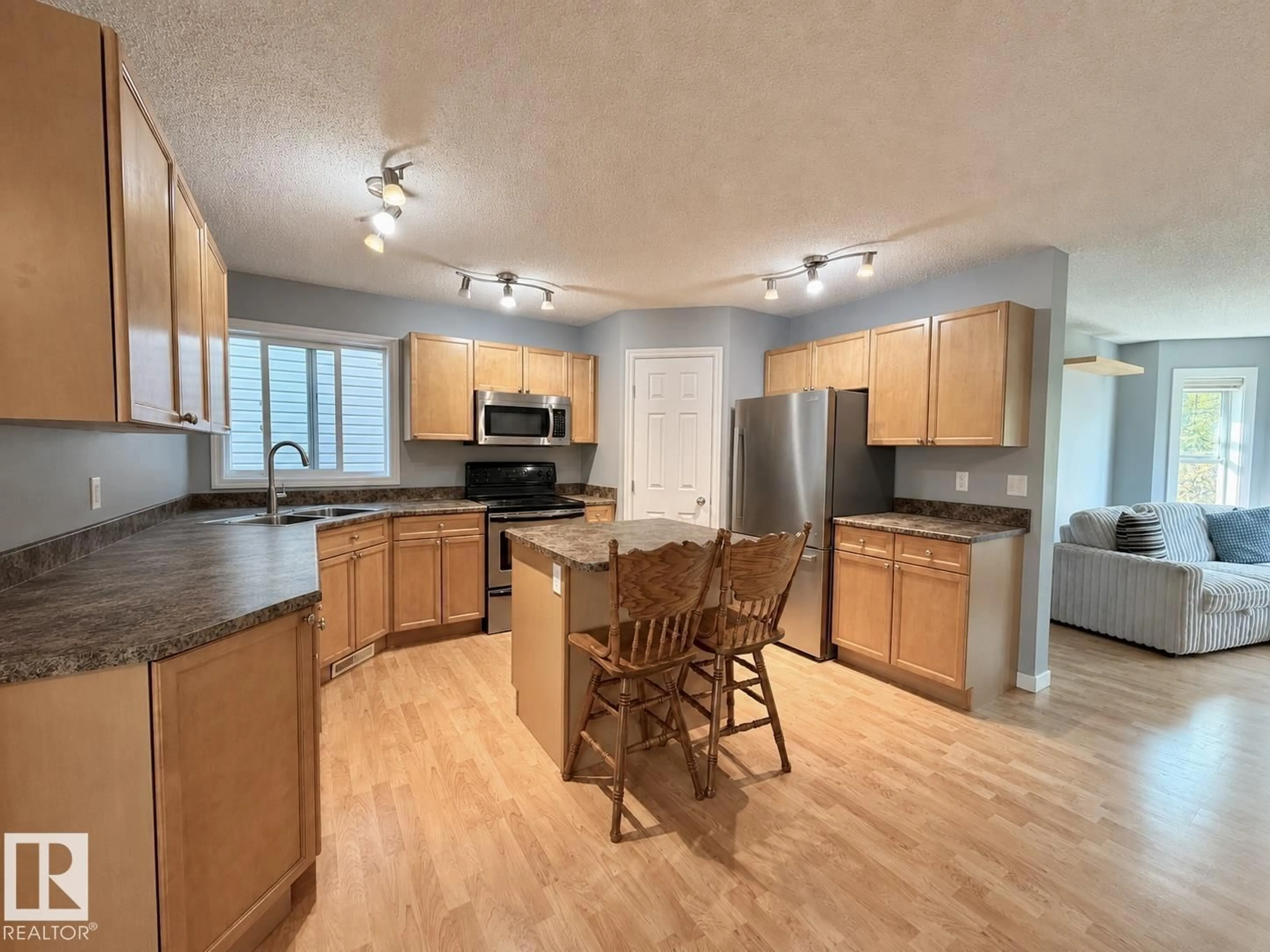 Open concept kitchen, wood/laminate floor for 105 KEYSTONE CR, Leduc Alberta T9E0J4