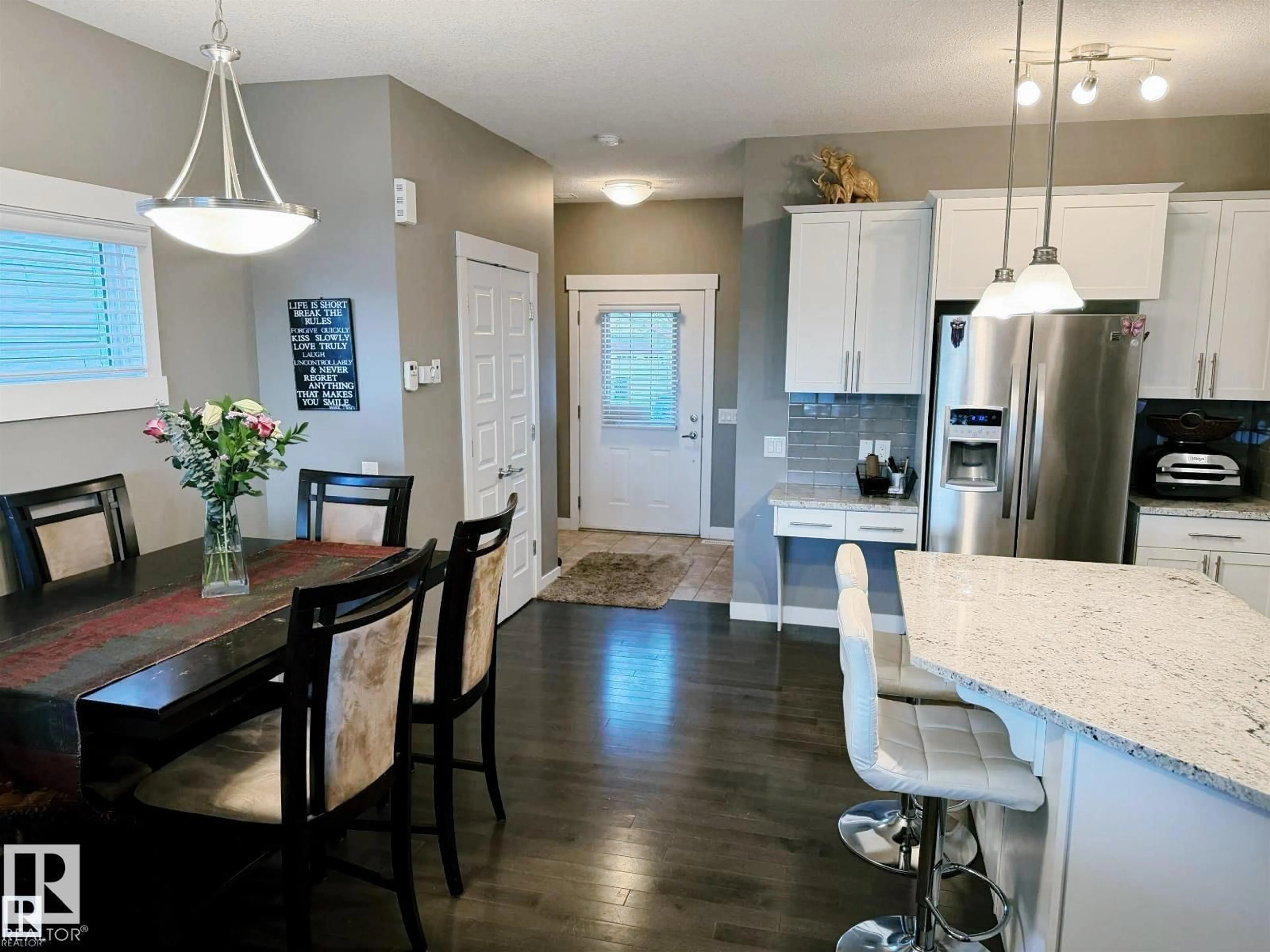 Open concept kitchen, wood/laminate floor for 7028 174 AV, Edmonton Alberta T5Z0L3