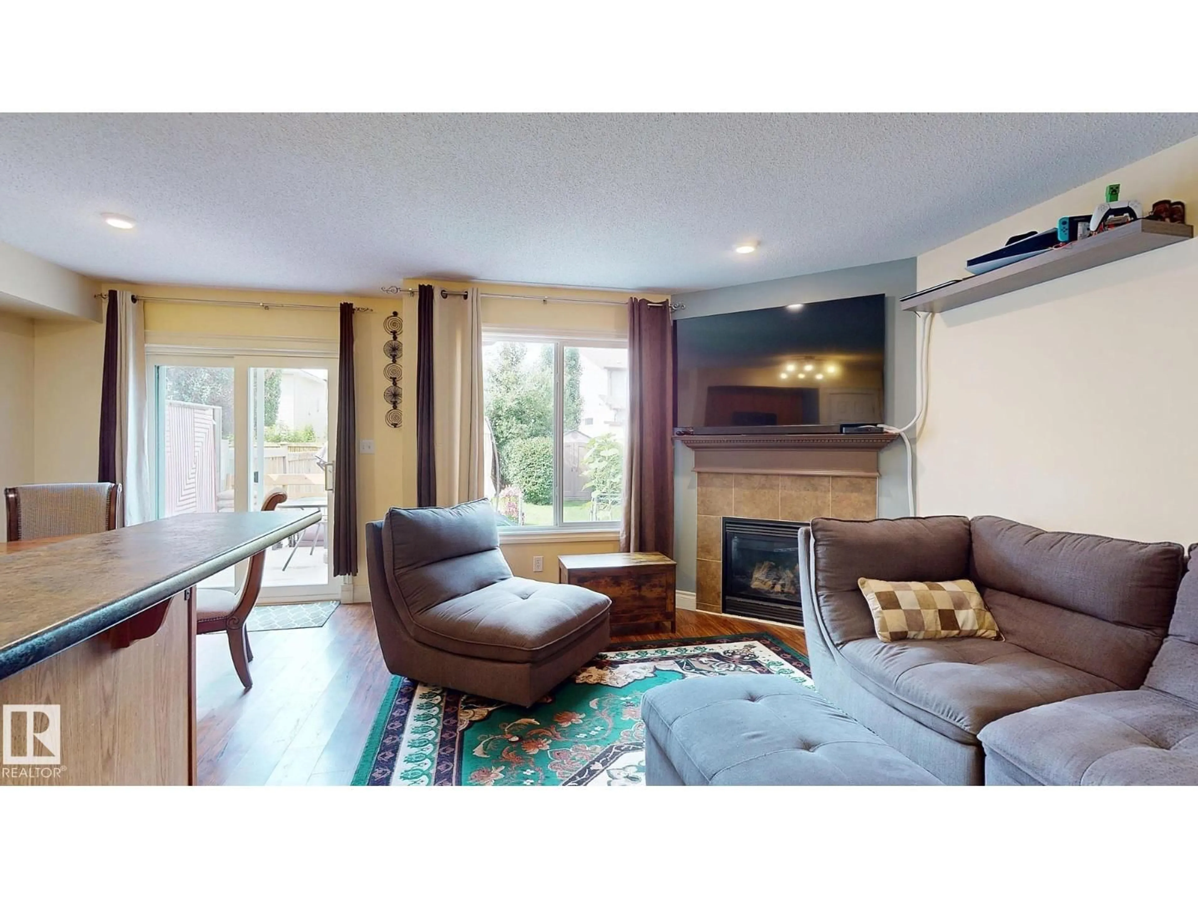 Living room with furniture, wood/laminate floor for 107 HARTWICK LO, Spruce Grove Alberta T7X0A5