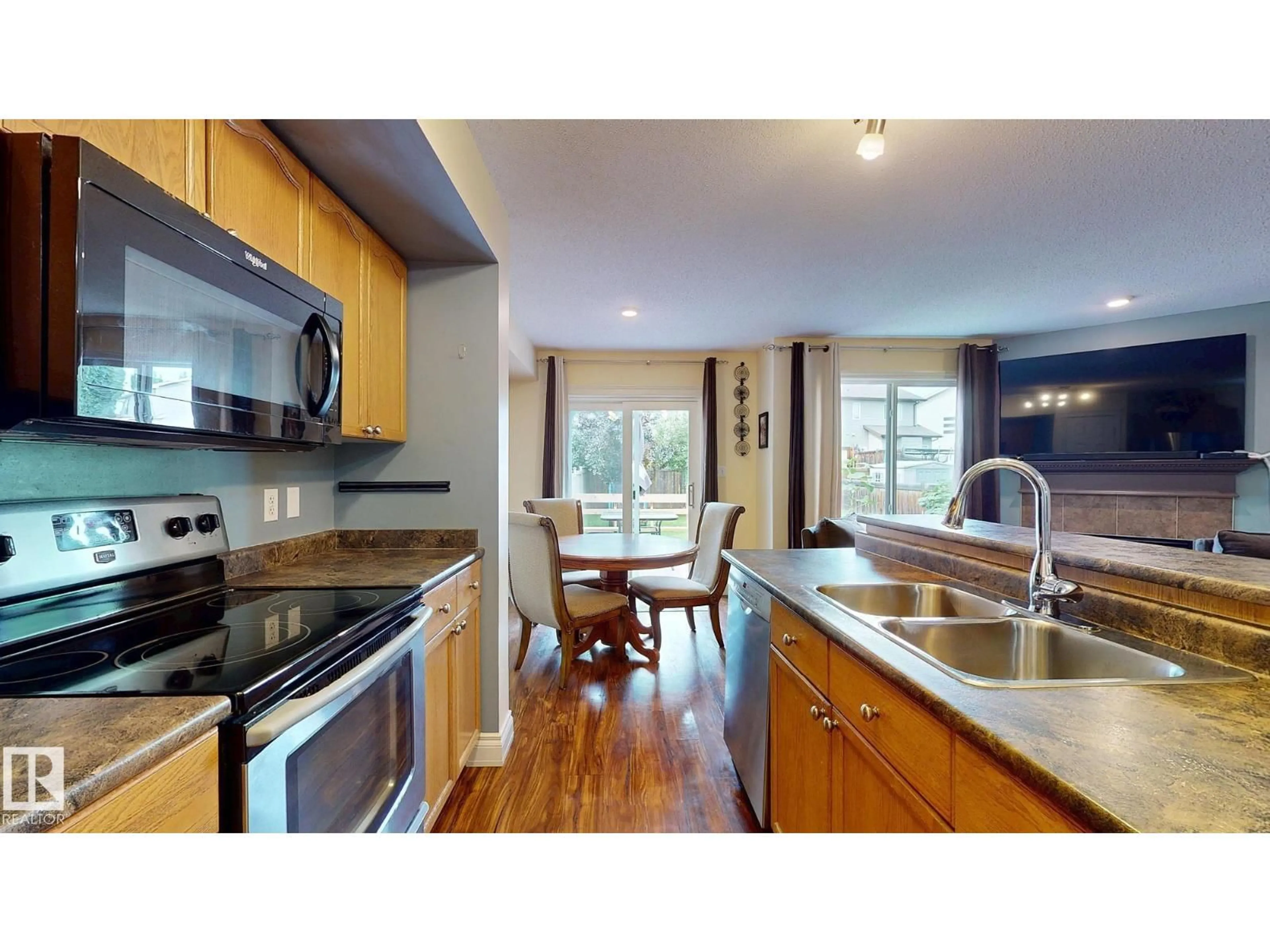Open concept kitchen, wood/laminate floor for 107 HARTWICK LO, Spruce Grove Alberta T7X0A5