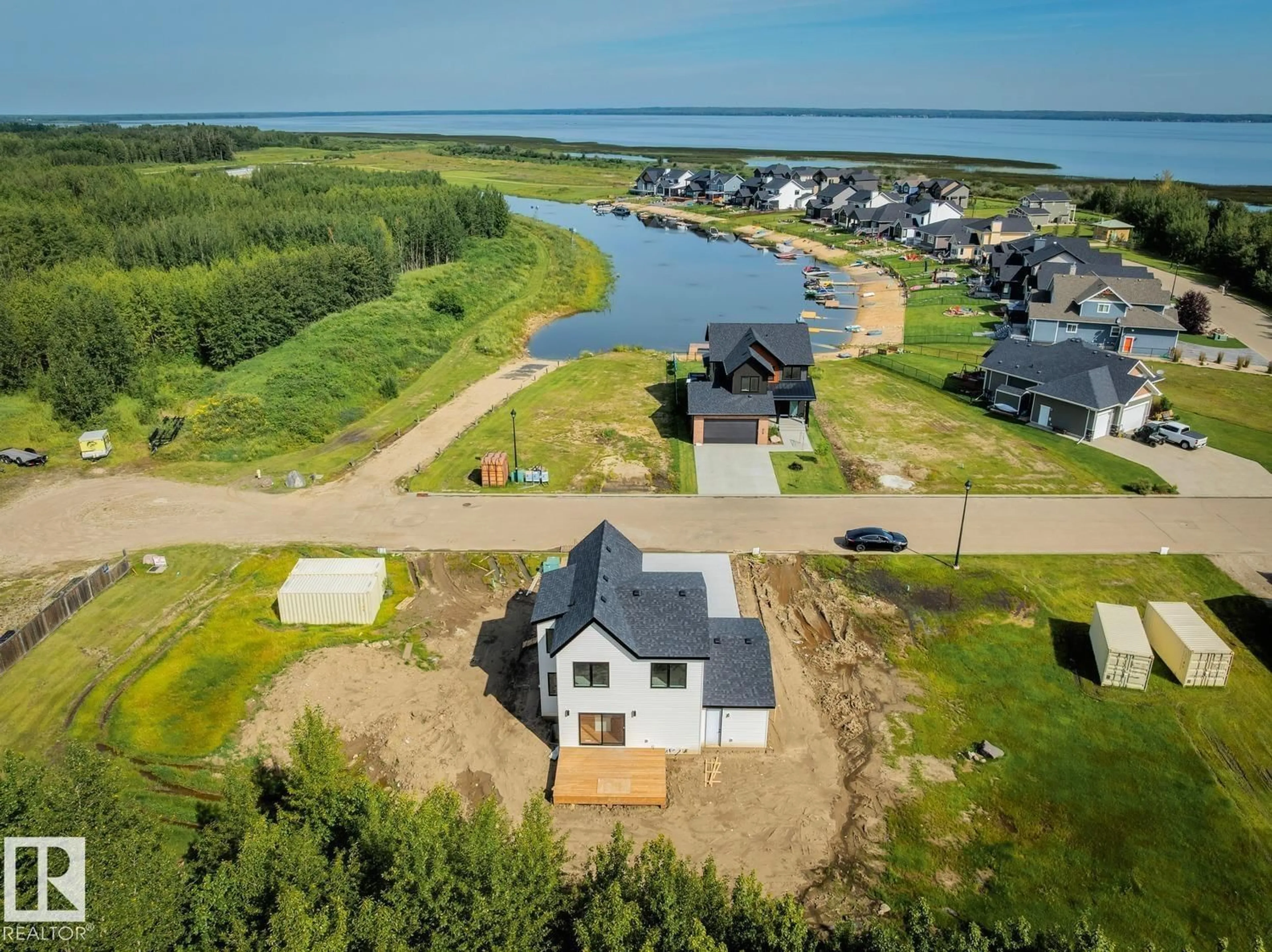 A pic from outside/outdoor area/front of a property/back of a property/a pic from drone, water/lake/river/ocean view for 207 - 3410 STE ANNE TR, Rural Lac Ste. Anne County Alberta T0E0A1