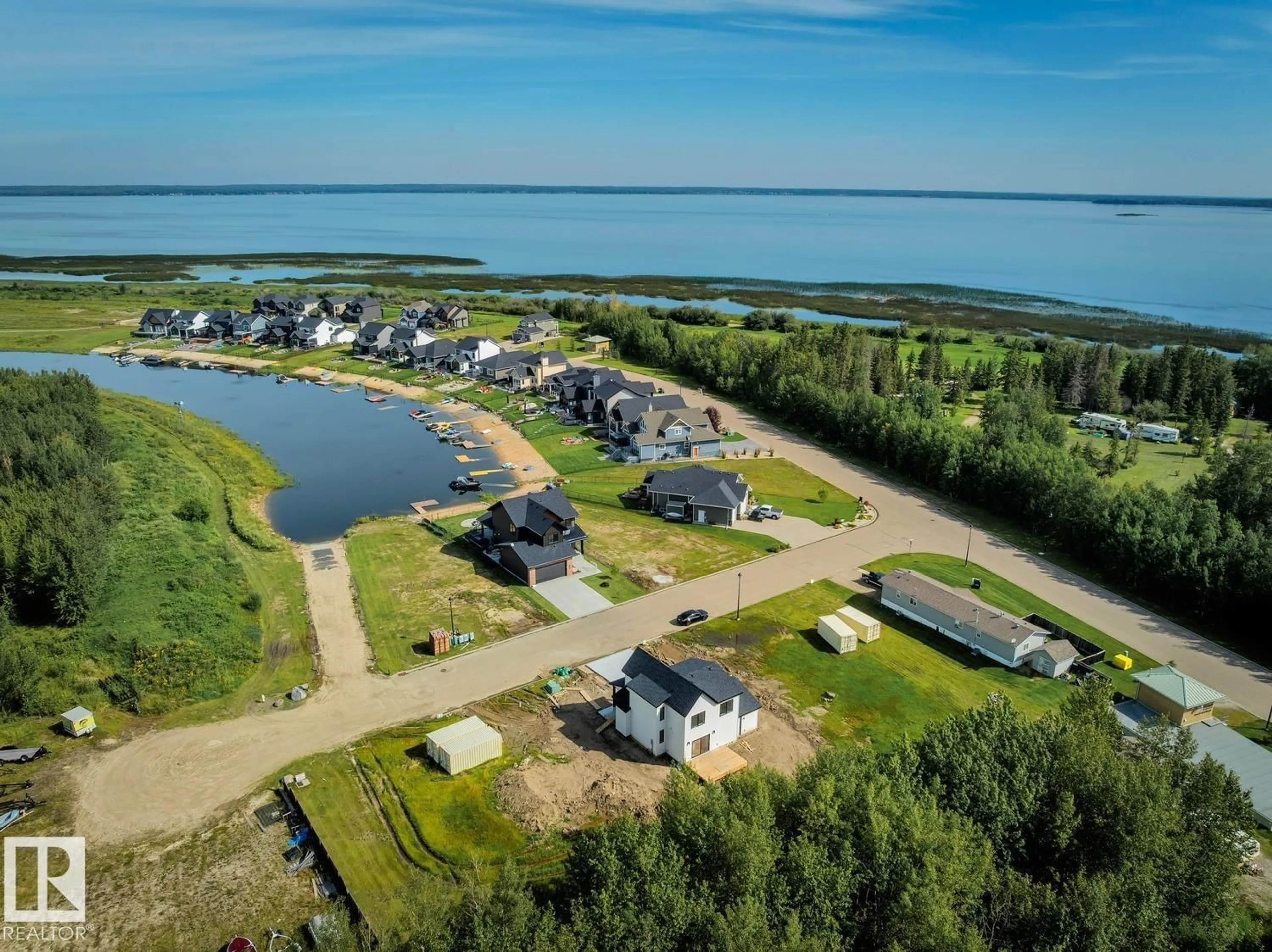 A pic from outside/outdoor area/front of a property/back of a property/a pic from drone, water/lake/river/ocean view for 207 - 3410 STE ANNE TR, Rural Lac Ste. Anne County Alberta T0E0A1
