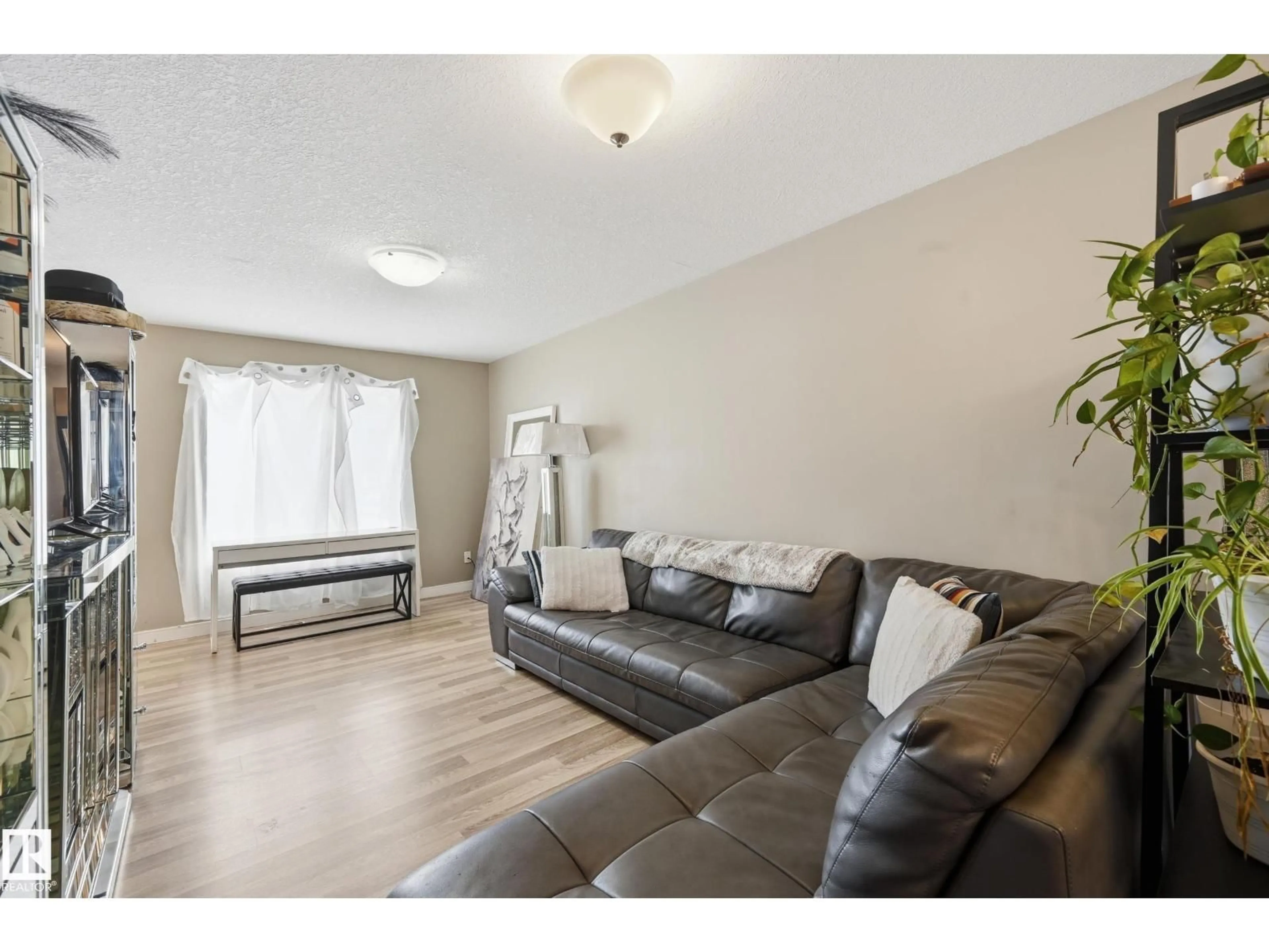 Living room with furniture, wood/laminate floor for 8816/8818/8820 119 AV, Edmonton Alberta T5B0G3