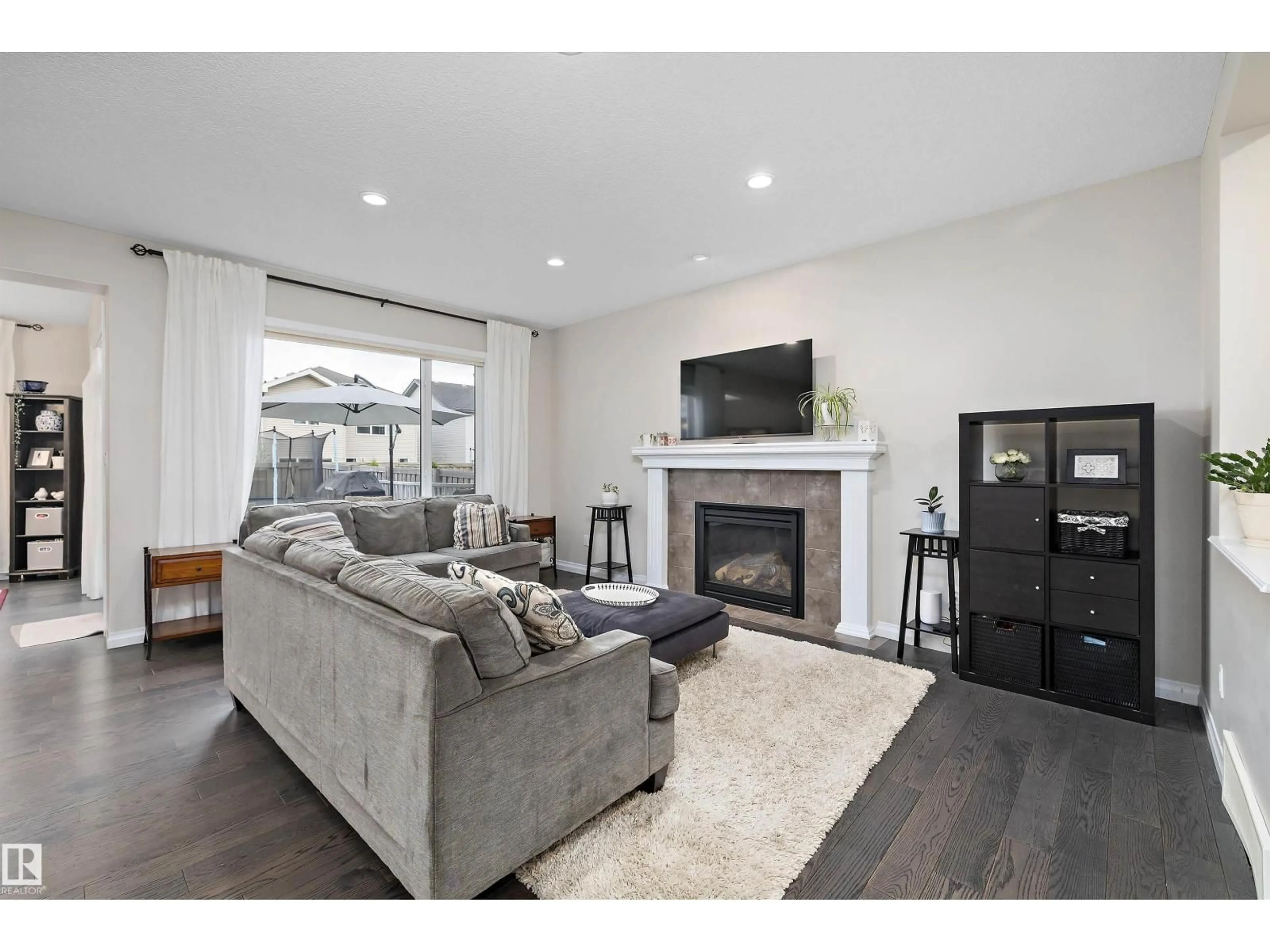 Living room with furniture, wood/laminate floor for 4015 ALEXANDER WY, Edmonton Alberta T6W2C5