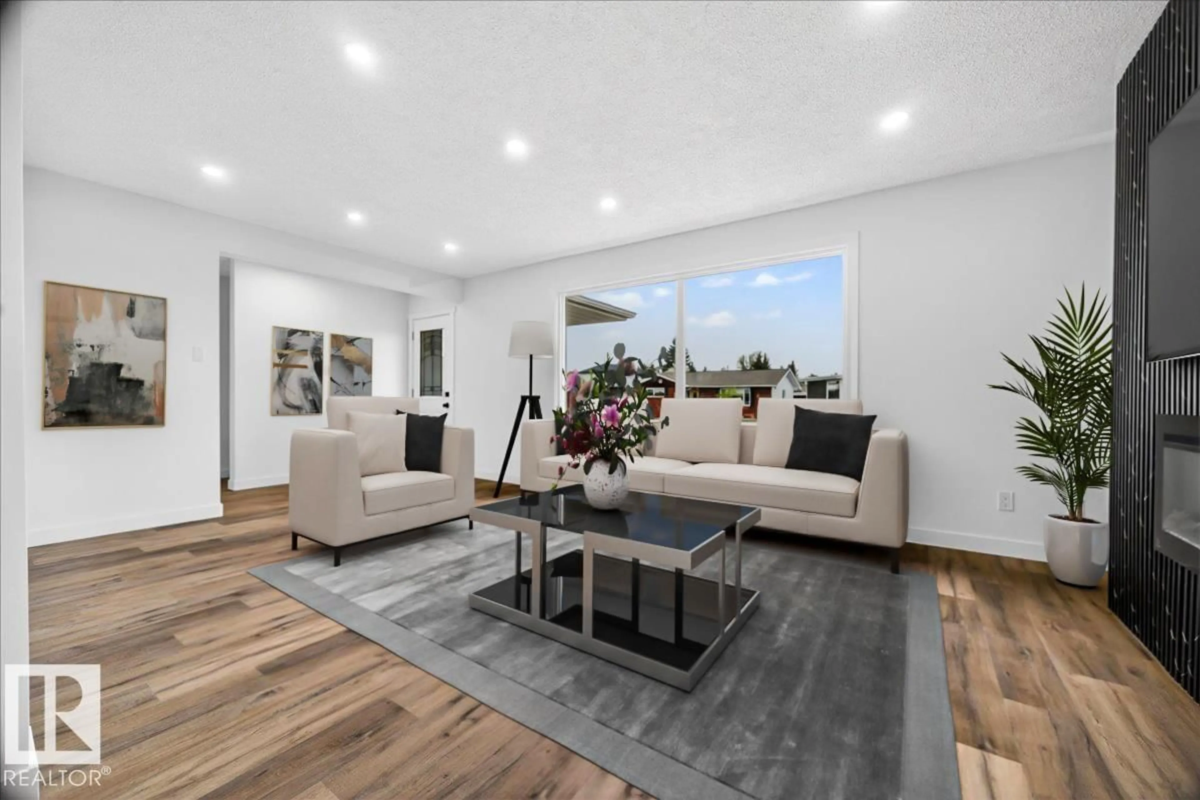 Living room with furniture, wood/laminate floor for 7823 148 AV, Edmonton Alberta T5C2T8