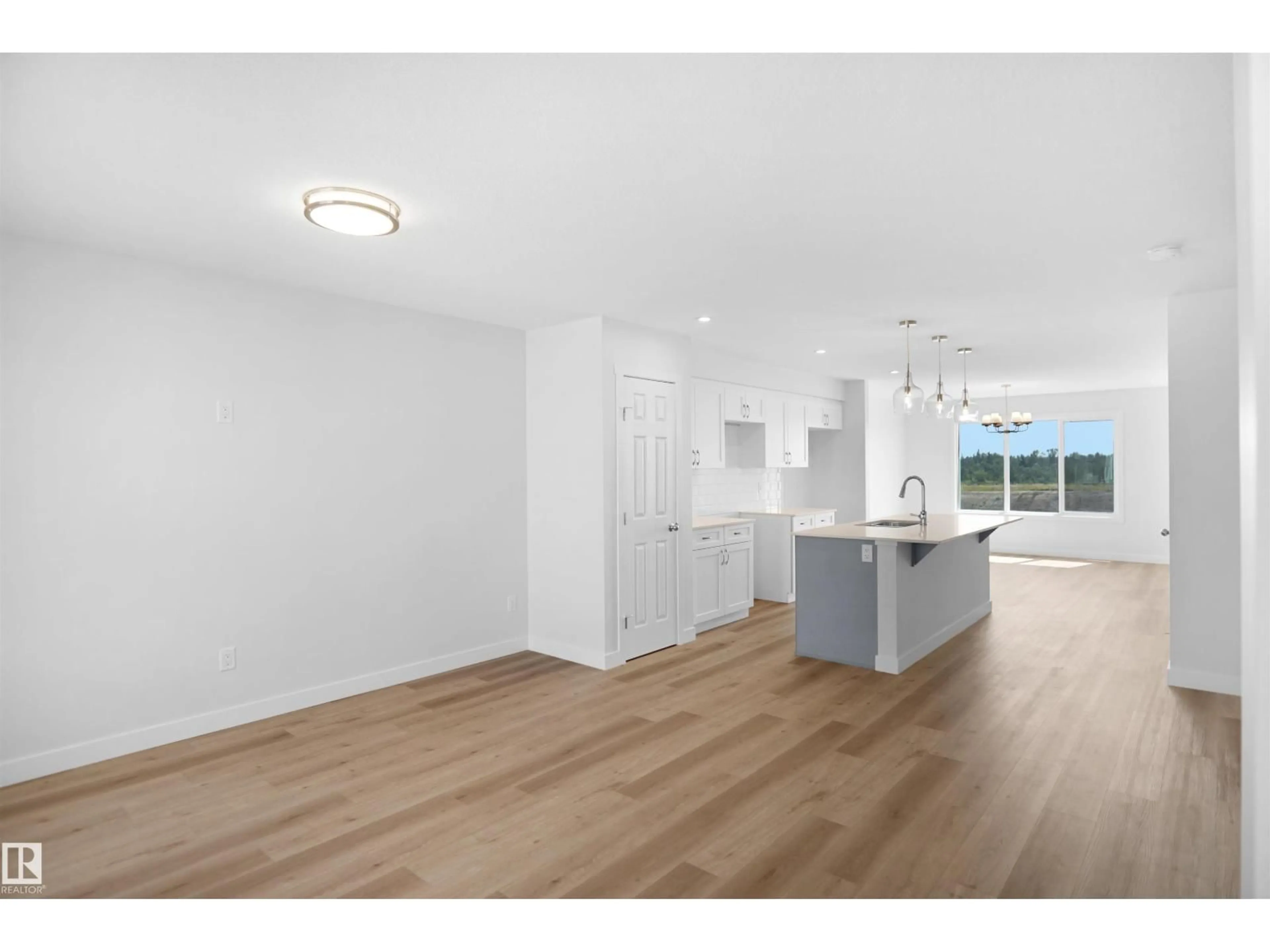 Open concept kitchen, wood/laminate floor for 106 JUNIPER WD, Fort Saskatchewan Alberta T8L3S4