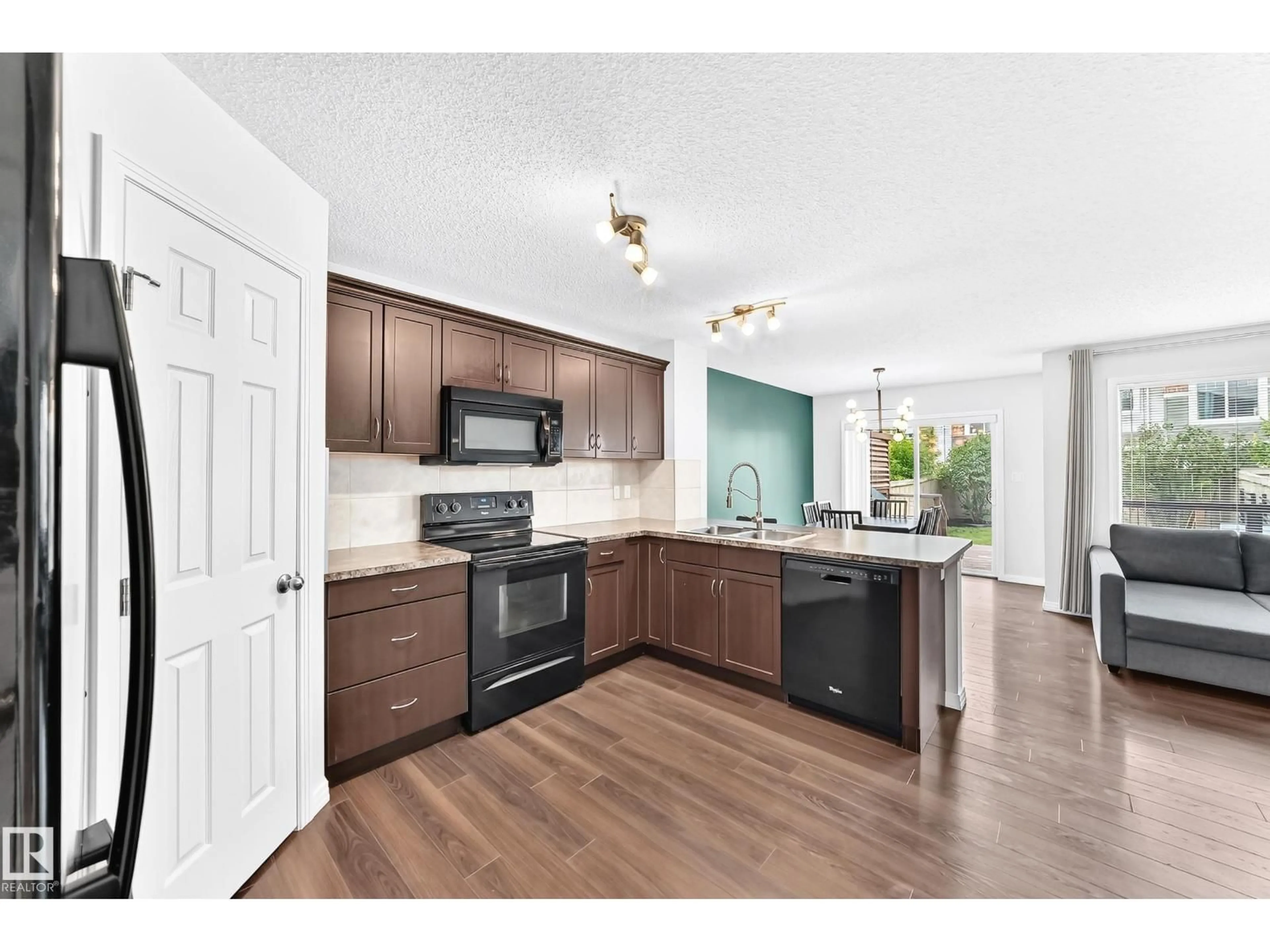Open concept kitchen, wood/laminate floor for 3920 6 ST, Edmonton Alberta T6T0T5