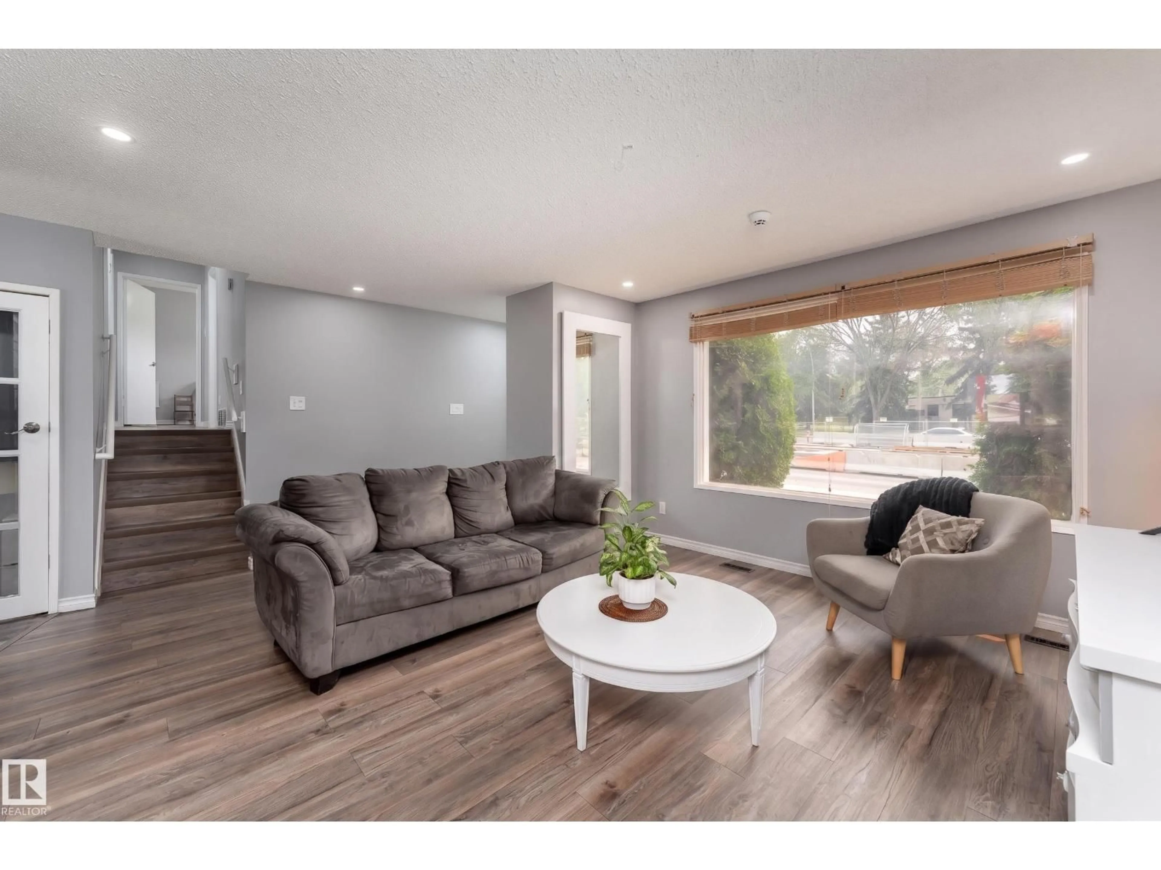 Living room with furniture, wood/laminate floor for 9012 MEADOWLARK RD, Edmonton Alberta T5R5W8